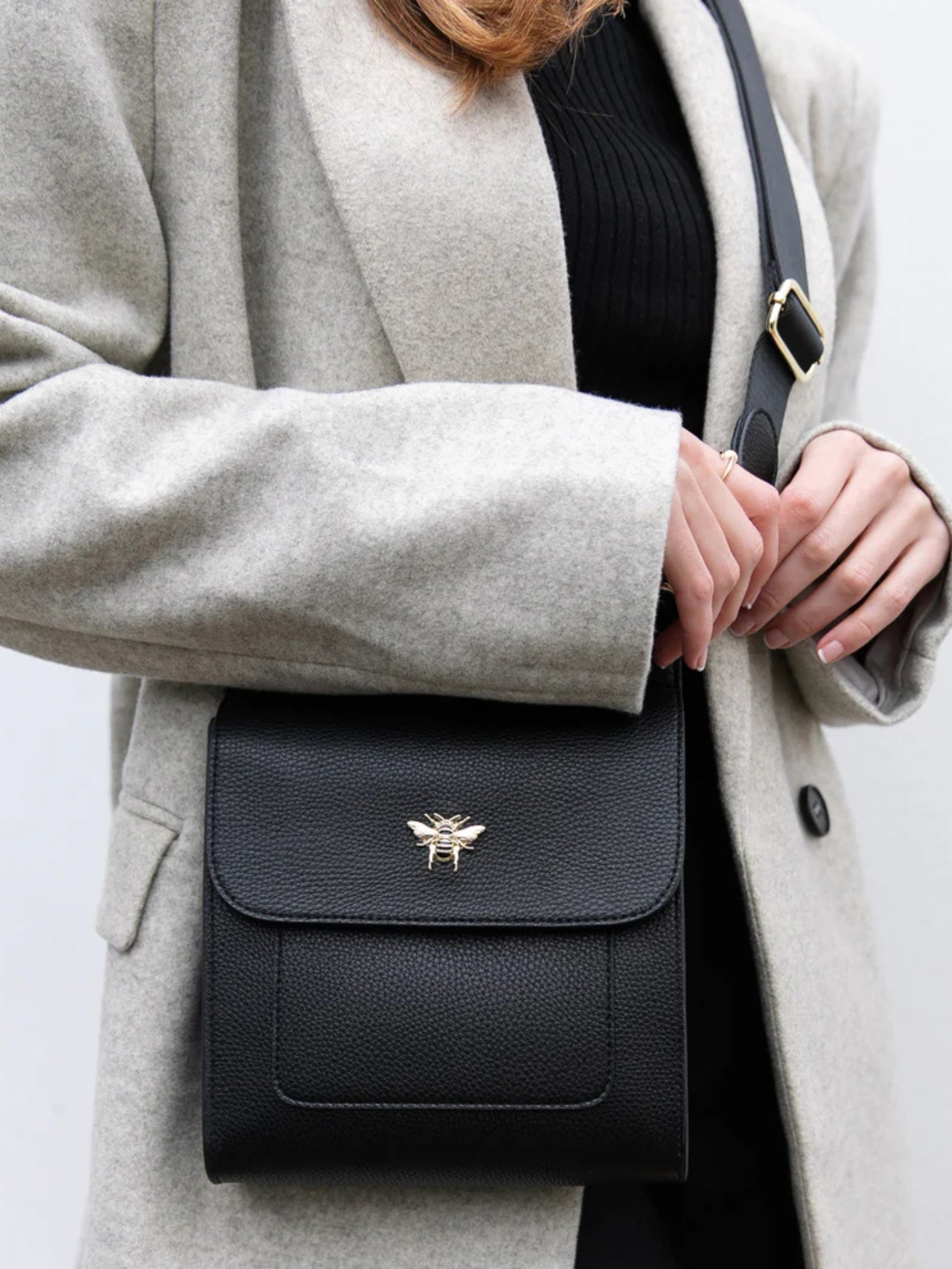 ALICE WHEELER AW5571 black Bloomsbury cross body bag in vegan leather with gold hardware, magnetic flap closure and adjustable strap.