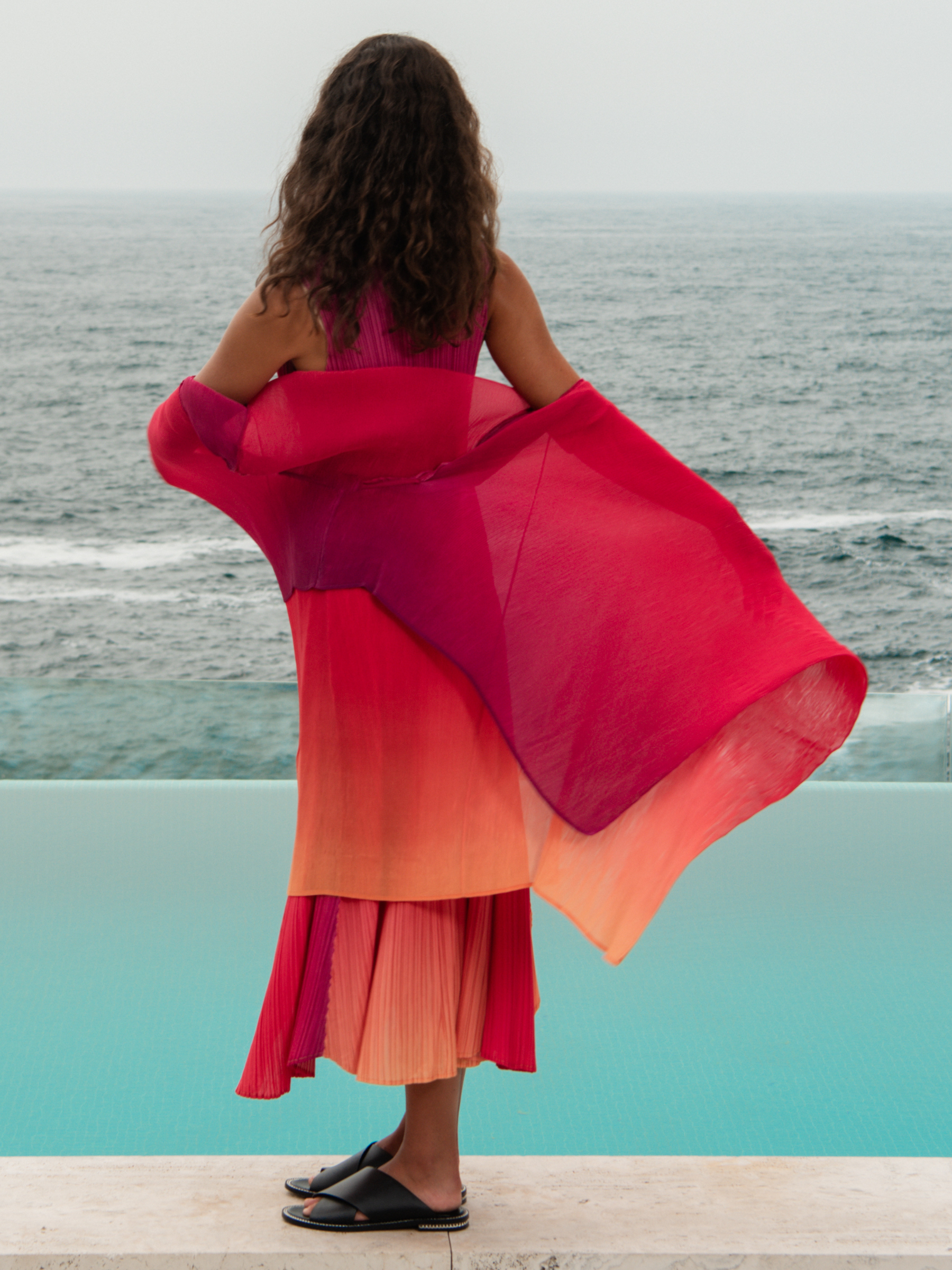 Alquema Festival Sunrise Dress & Coat hand-pleated dress and coat set with pink and coral ombré, flowing silhouette and draped sleeves.