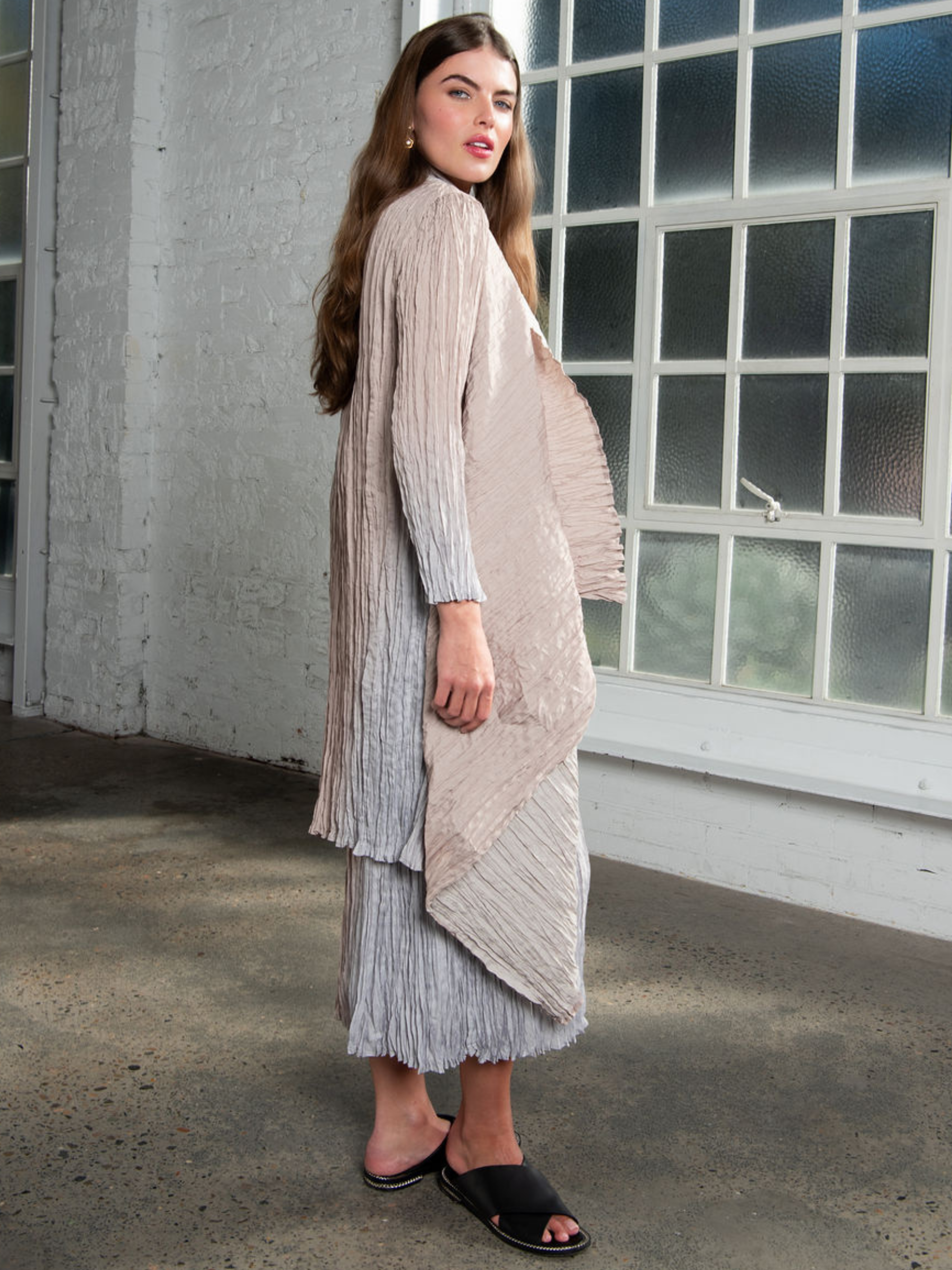 Alquema Silver Sand Dress & Coat featuring a hand-pleated layered silhouette with flowing dress and coordinating coat, styled as an elegant occasionwear outfit.