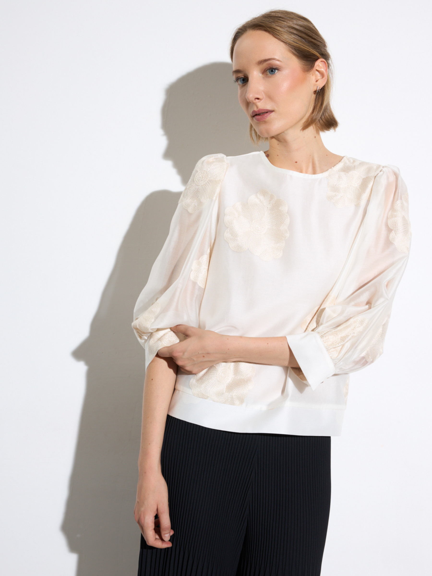 Bariloche Caoba Shirt with round neckline, three-quarter sleeves and delicate floral-inspired detailing in relaxed silhouette.