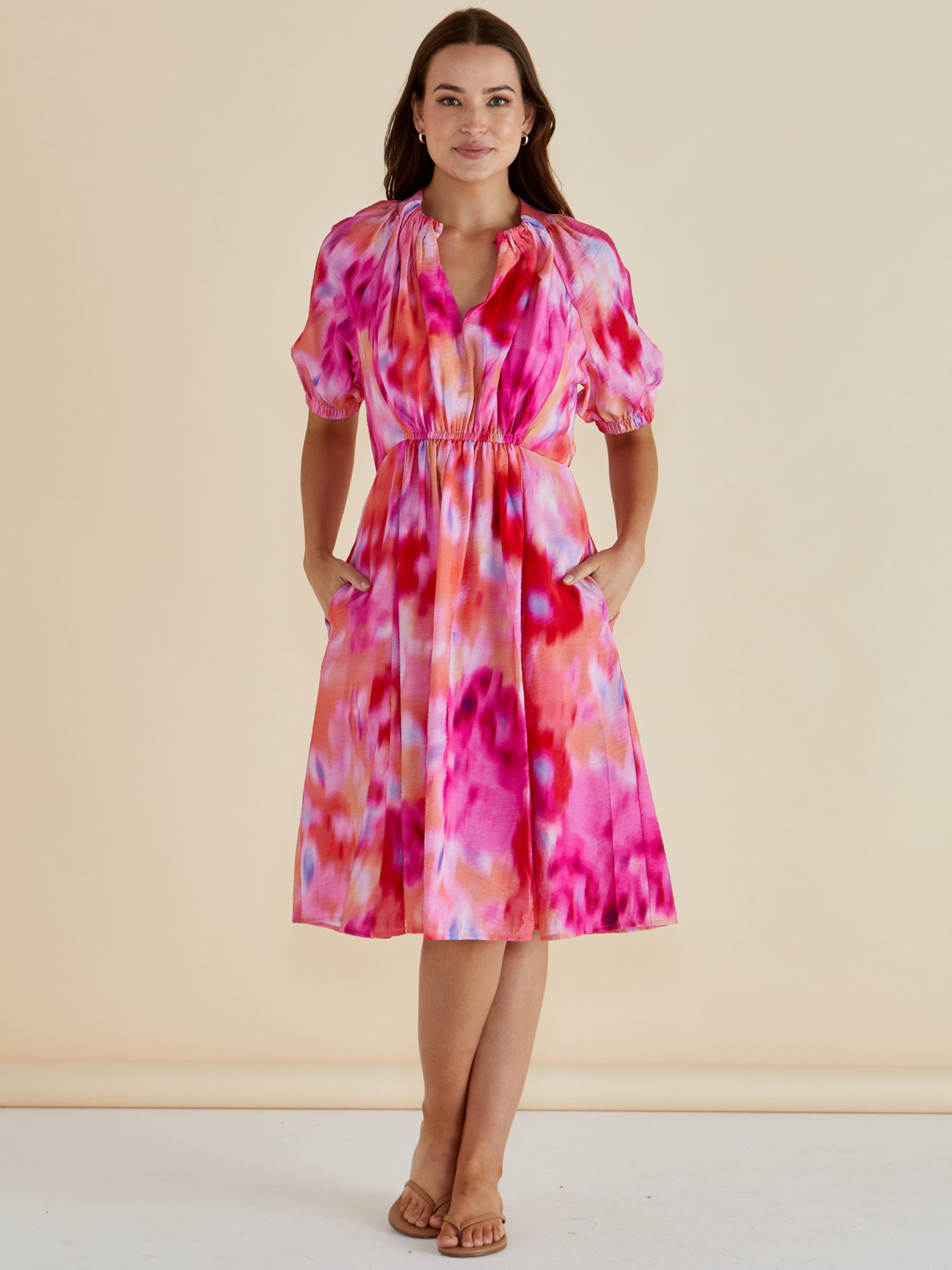 Betty Emery Dress with V-notch neckline, short puff sleeves, elasticated waist and midi-length A-line skirt.