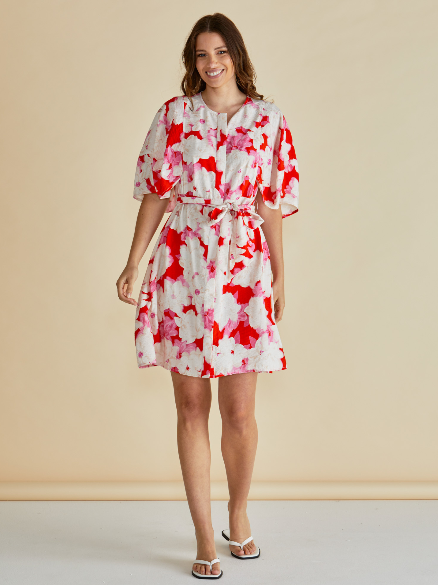 Betty Gwenda Dress with round neckline, button-through front, short sleeves and self-tie waist belt.
