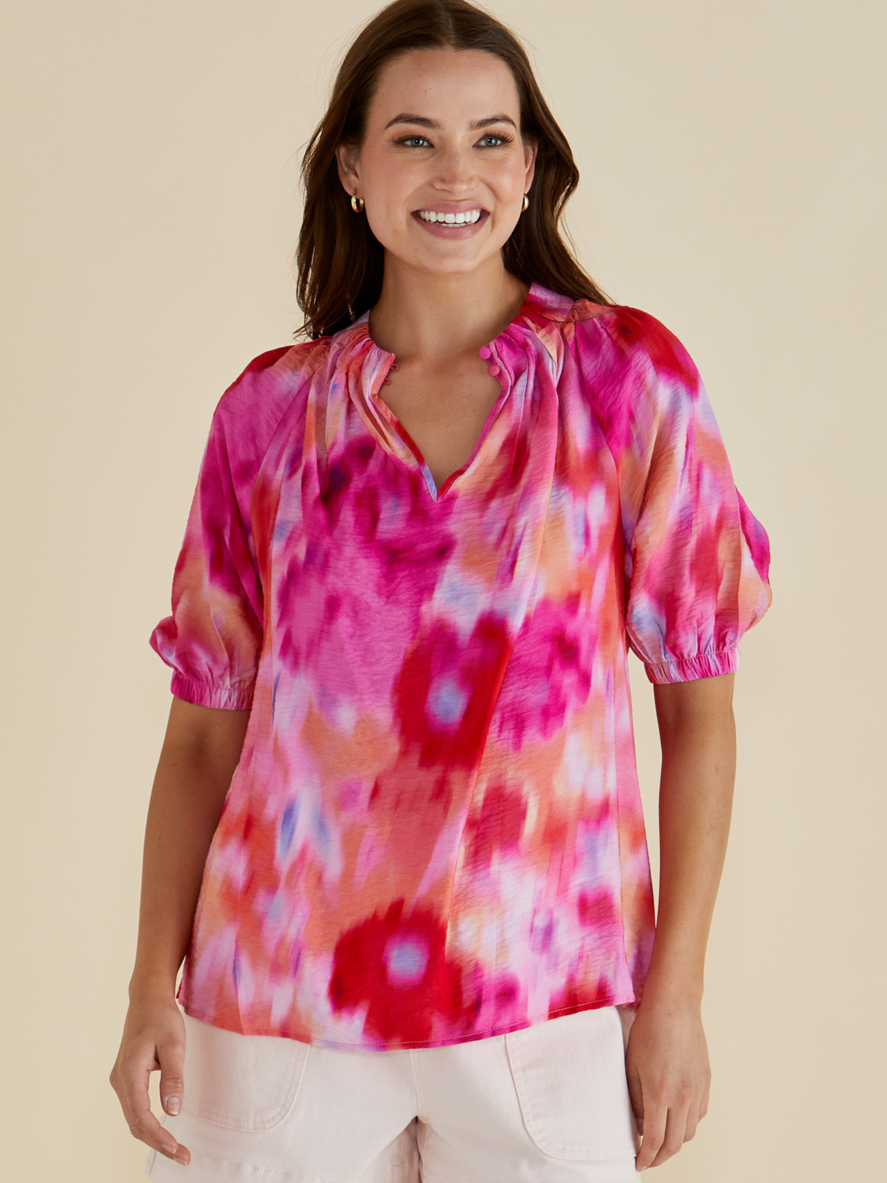 Betty Joanne Blouse with V-notch neckline, short puff sleeves and abstract floral print.
