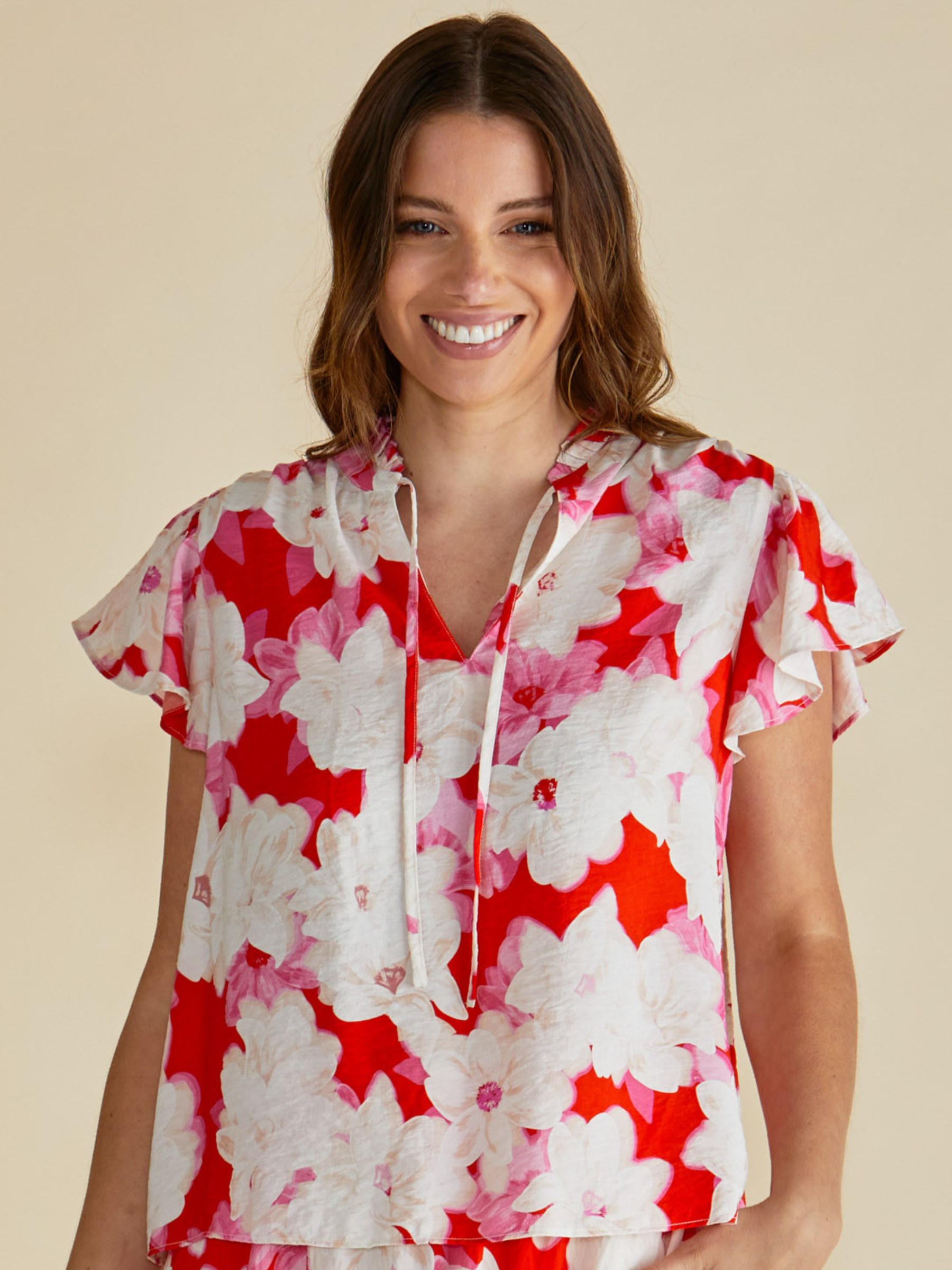 Betty Lyra Blouse with V neckline, tie detail and short flutter sleeves.