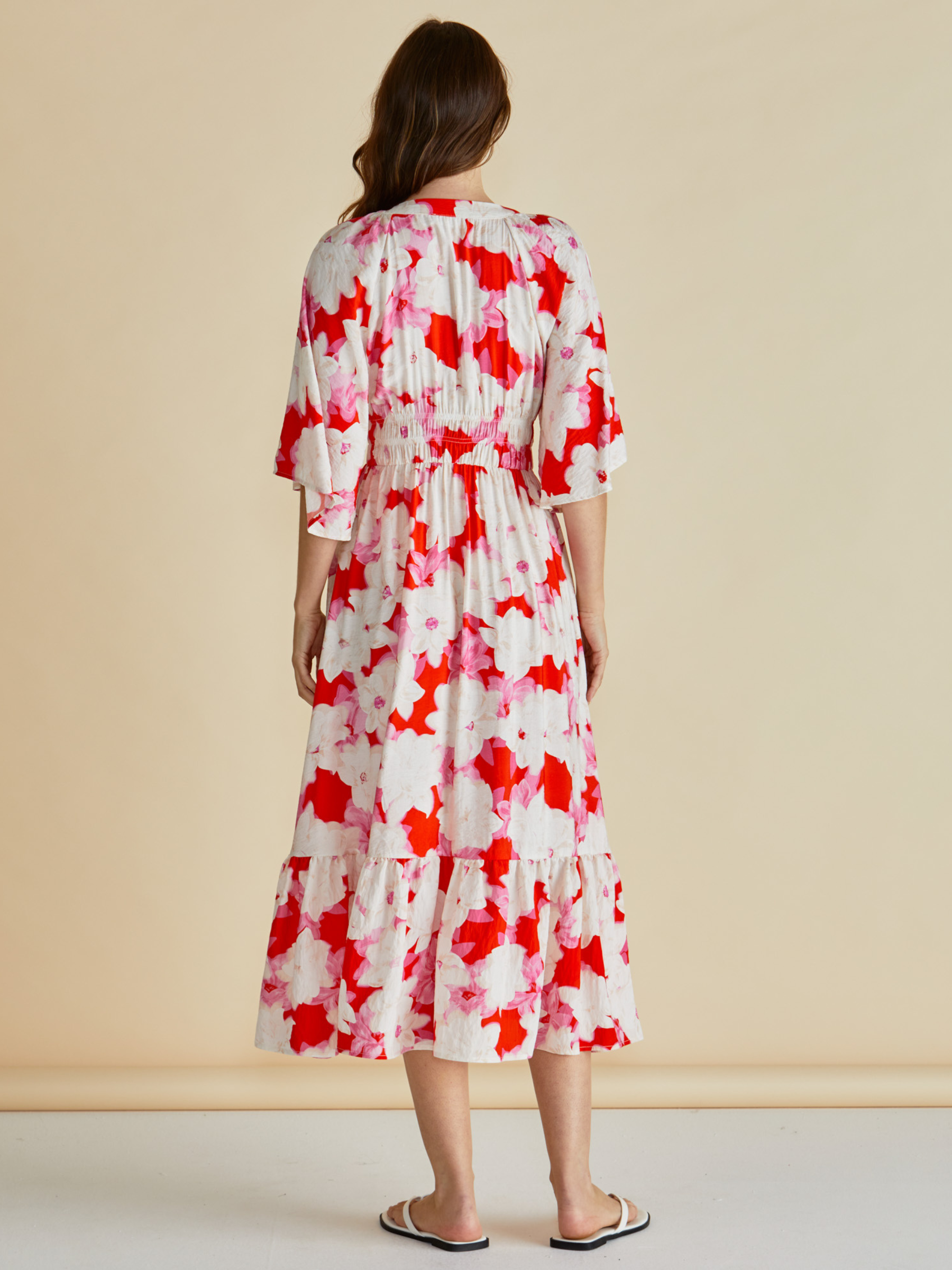 Betty Moxie Dress with V neckline, button-through front, flutter sleeves, elasticated waist and tiered skirt.