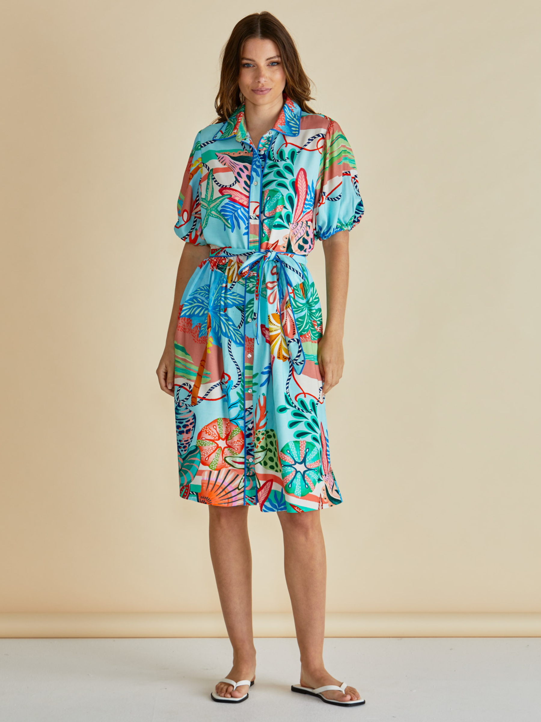 Betty Rio Reef Dress with shirt collar, button-through front, puff sleeves and self-tie waist belt.