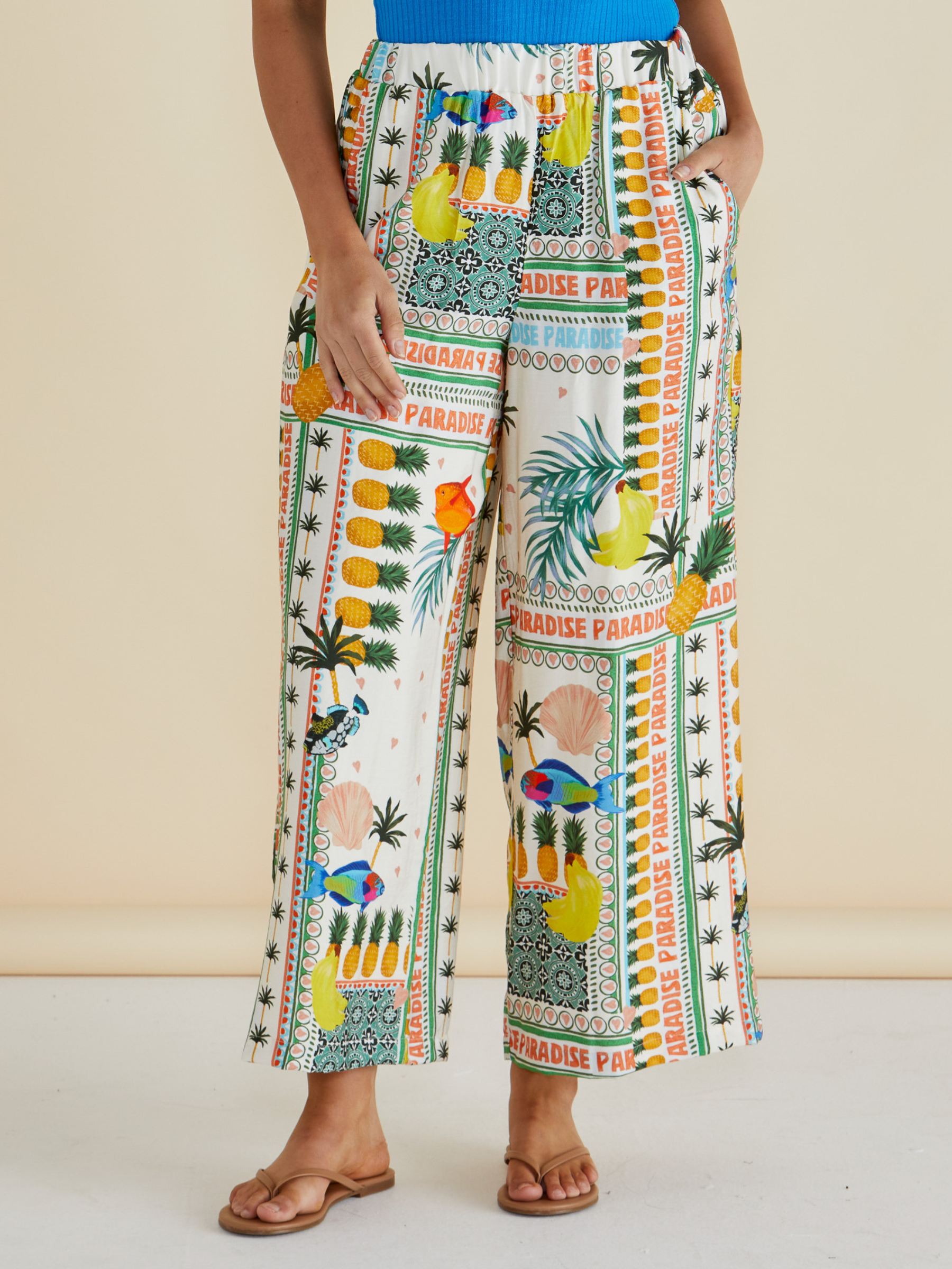Betty Sable Wide Leg Pant with elasticated waistband, wide-leg silhouette and colourful tropical “Paradise” patchwork print.