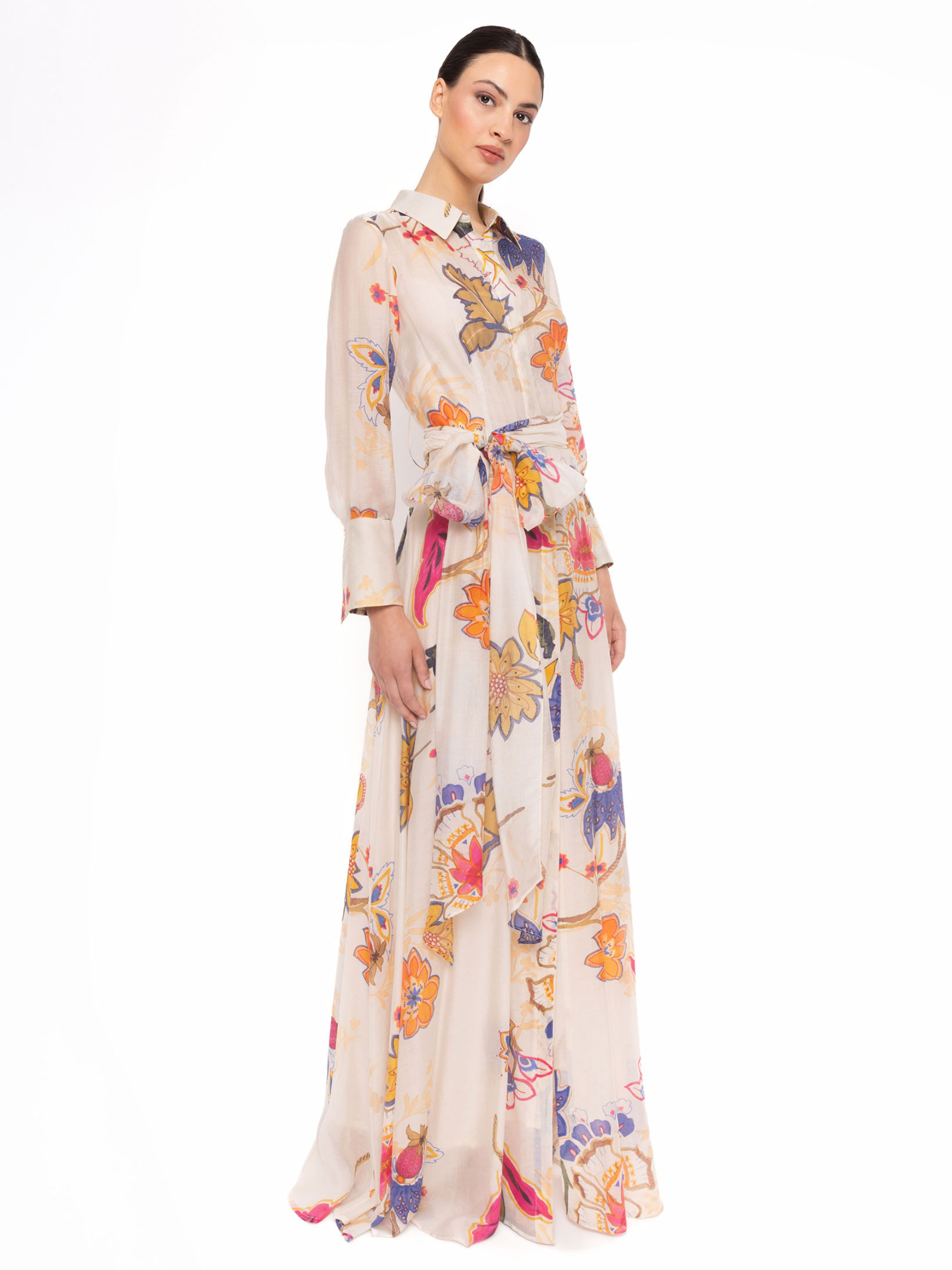 Carla Ruiz 152538 White Dress with botanical print, shirt-style neckline, tie-belt waist and flowing maxi skirt.