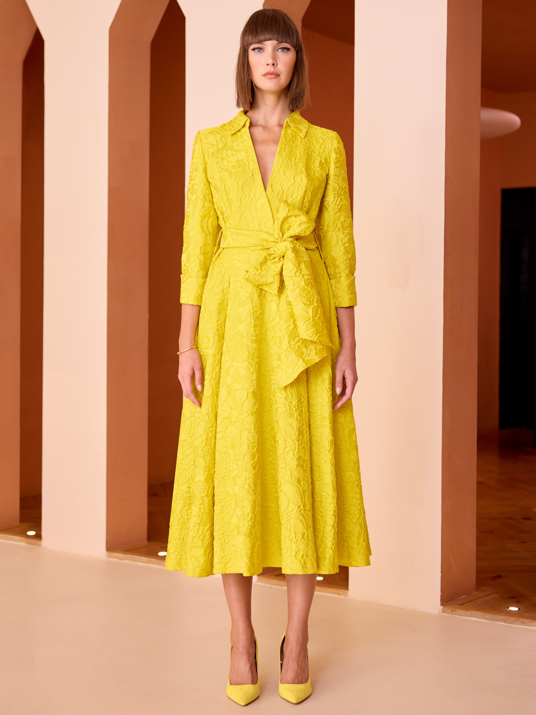 Carla Ruiz 52527 Yellow Dress with textured jacquard fabric, wrap-effect waist tie and A-line midi skirt.