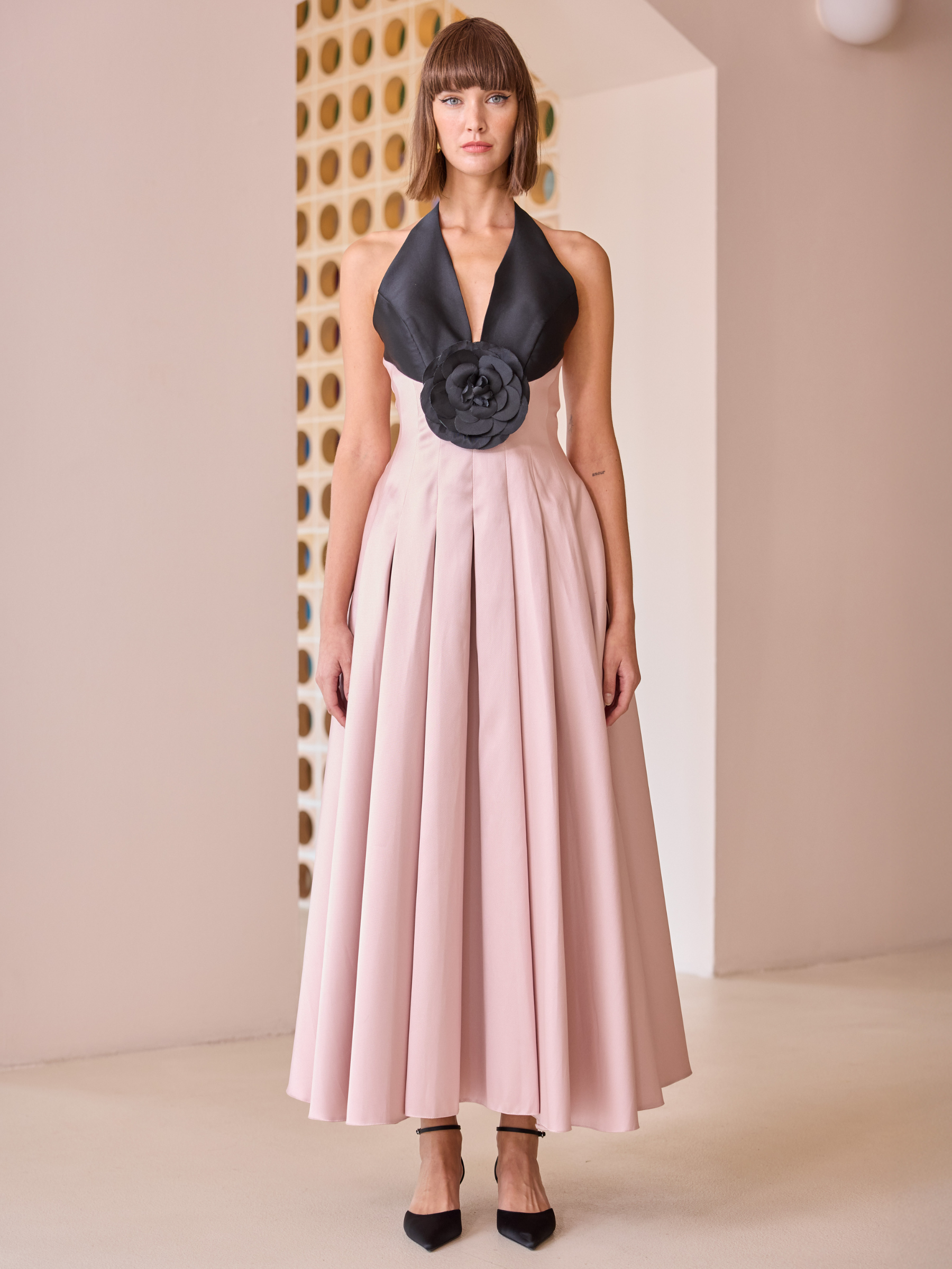Carla Ruiz 52623 pink halterneck dress with pleated skirt and statement floral waist detail.