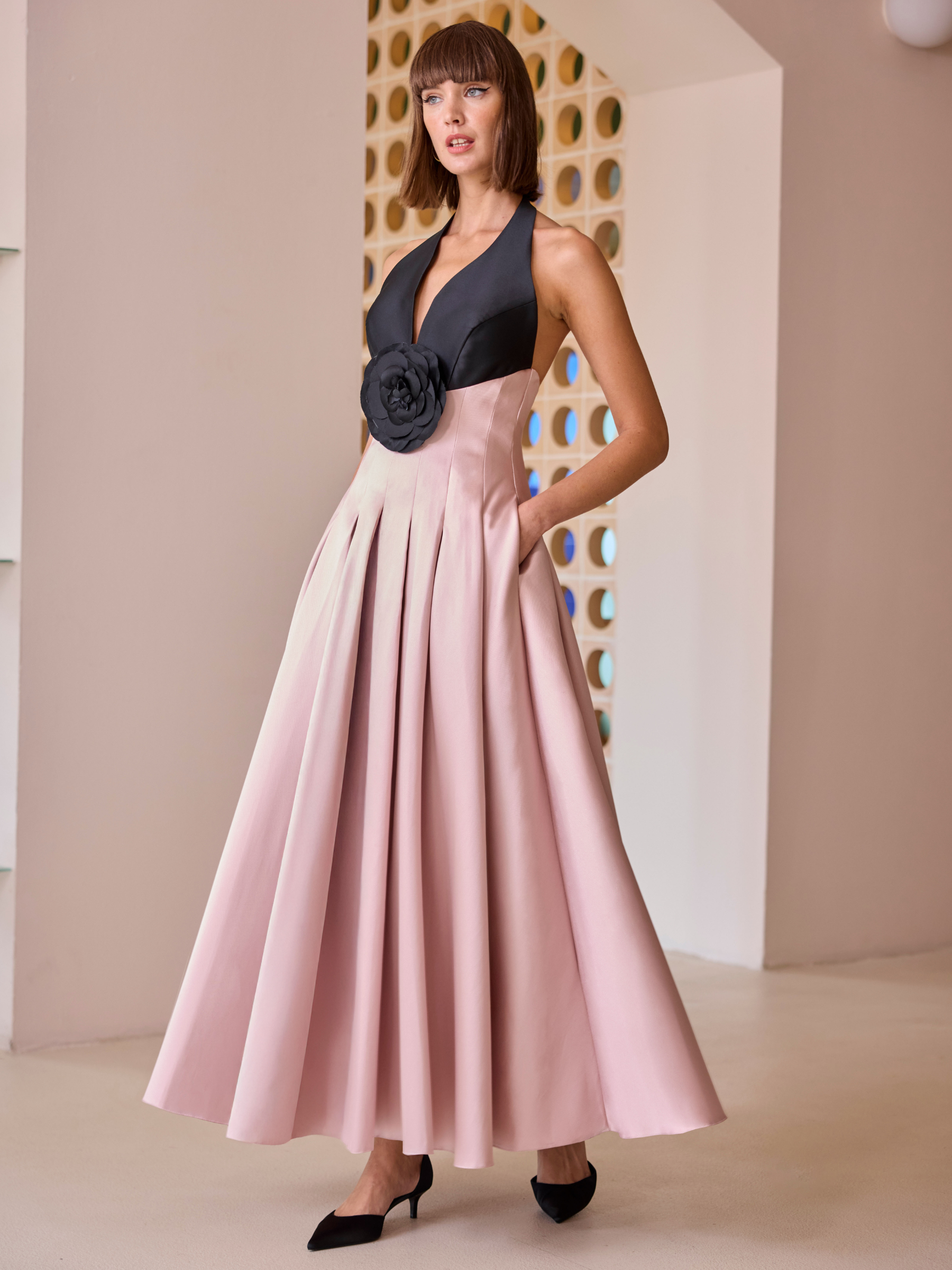 Carla Ruiz 52623 pink halterneck dress with pleated skirt and statement floral waist detail.