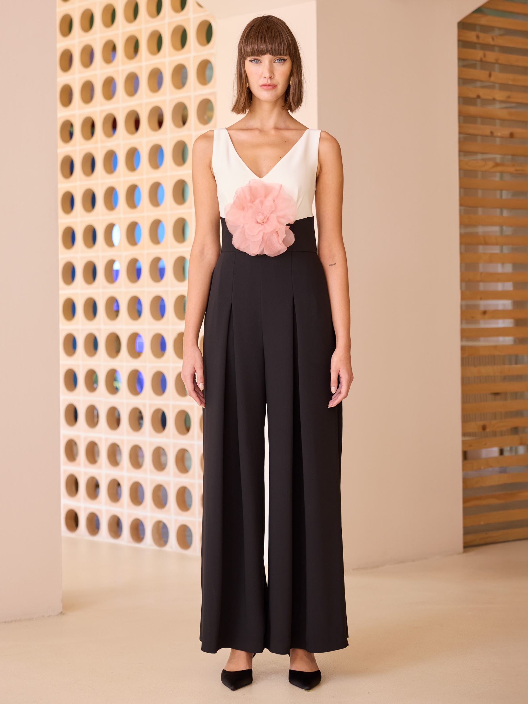 Carla Ruiz 52629 red jumpsuit with sleeveless V-neck bodice, floral waist detail and wide-leg trousers.