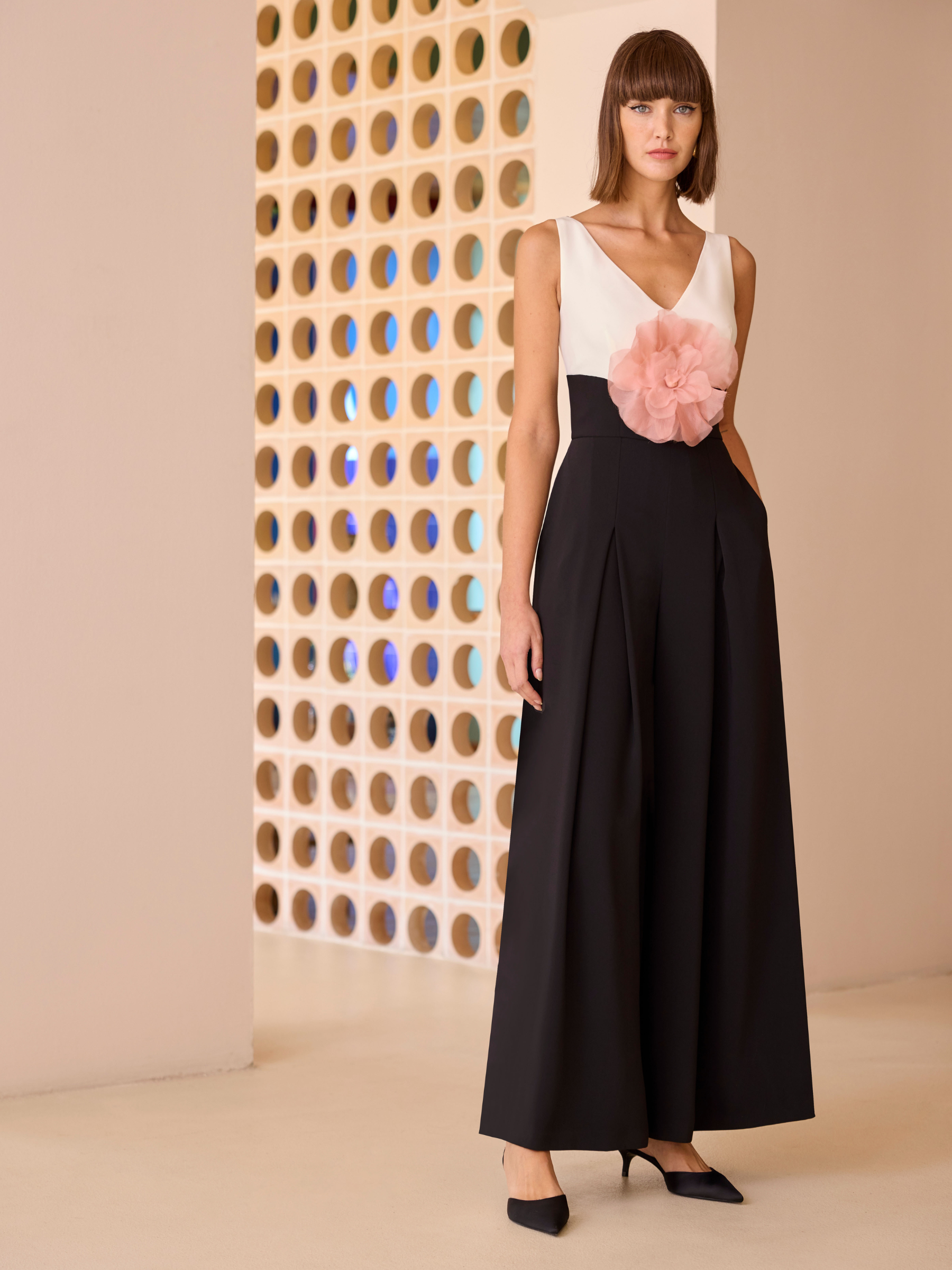 Carla Ruiz 52629 red jumpsuit with sleeveless V-neck bodice, floral waist detail and wide-leg trousers.