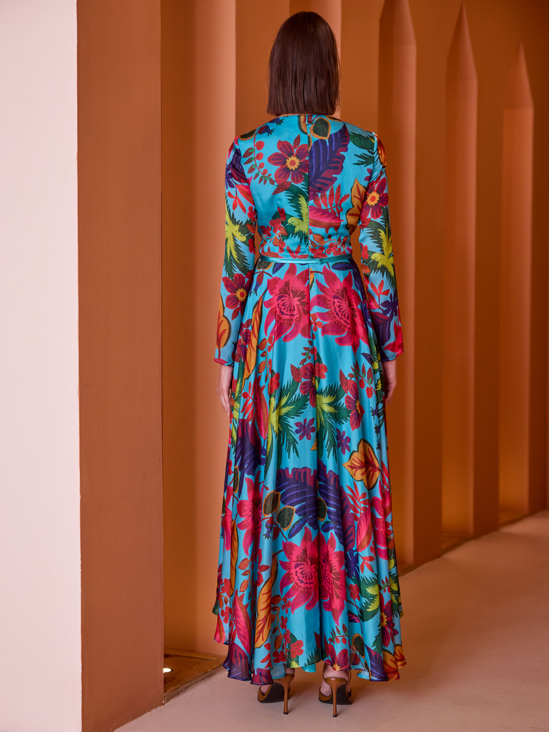 Carla Ruiz 52649 Turquoise Dress with tropical print, V-neckline, long sleeves and flowing asymmetric maxi skirt.