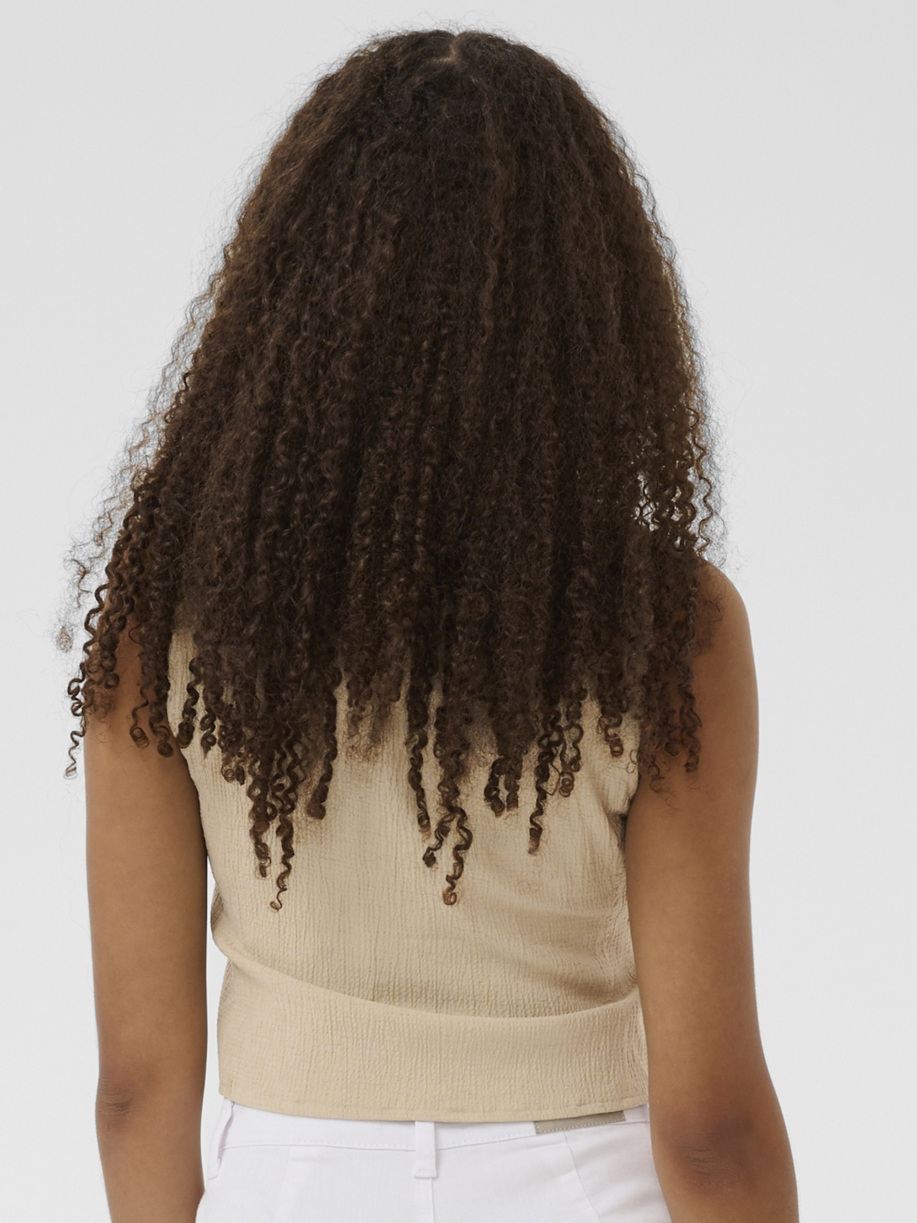 Cream Alva waistcoat with V-neckline and button front in a lightweight textured fabric.