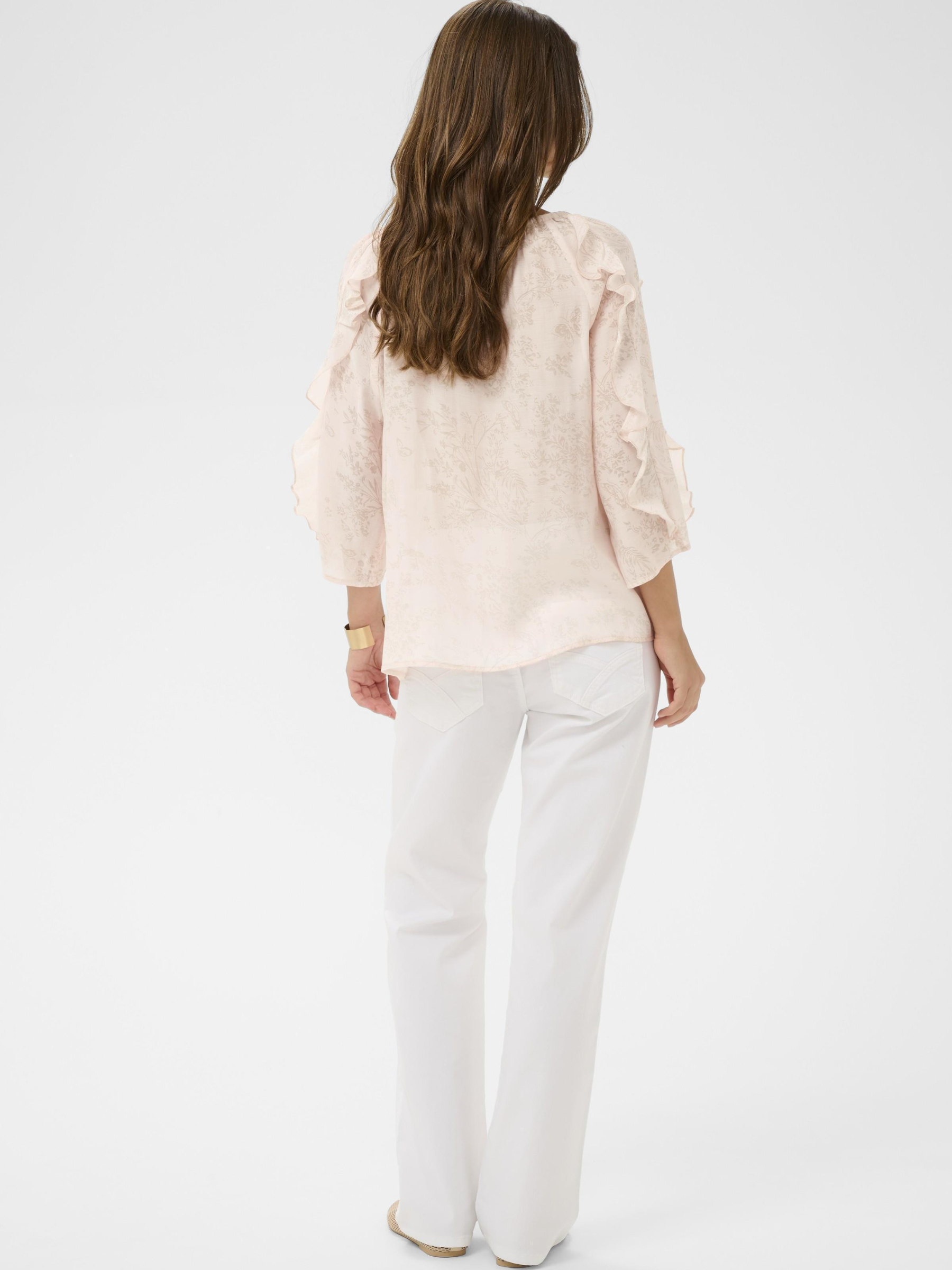 Cream Amy Blouse with gathered neckline, tie fastening and cascading ruffle sleeves in soft printed fabric.