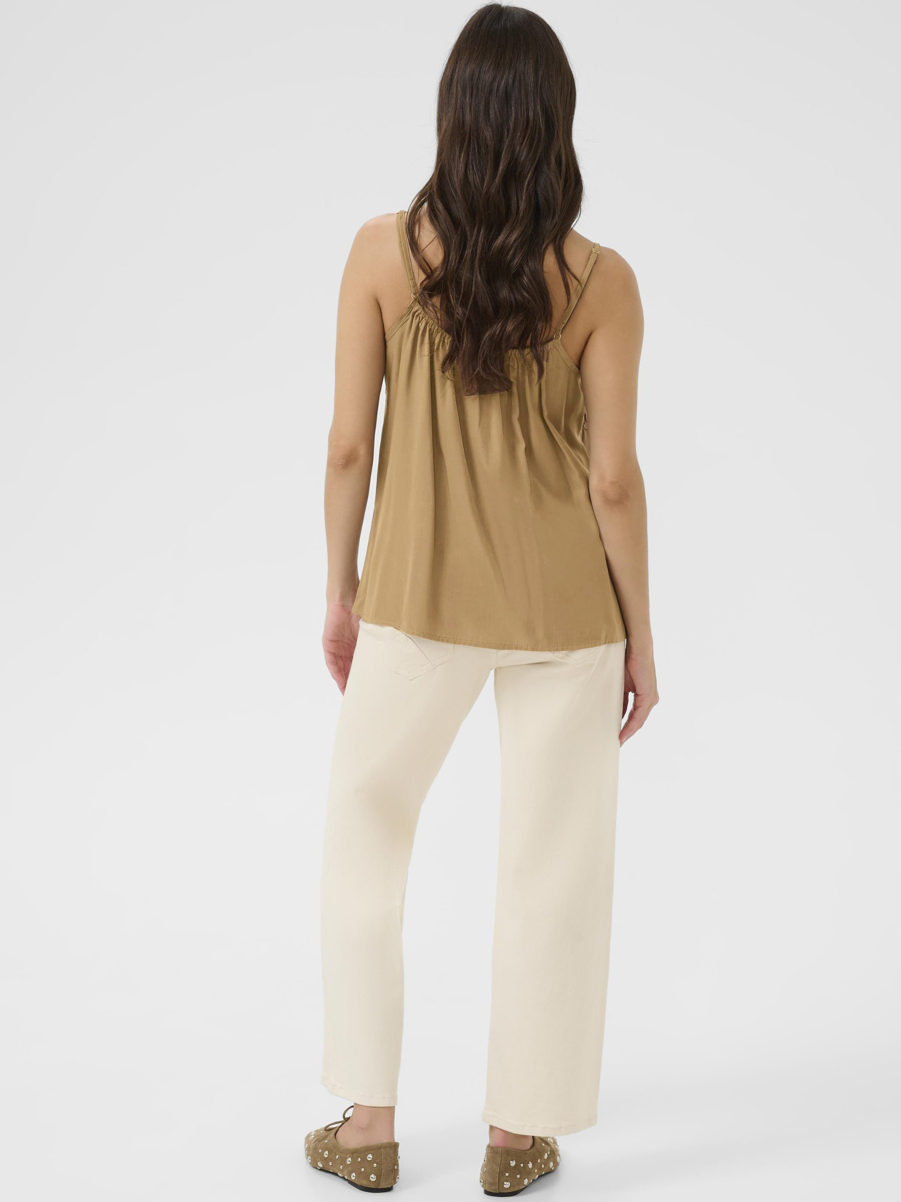 Cream Anna women’s A-line camisole top with lace neckline detail, adjustable straps and hip-length fit, styled with jeans.