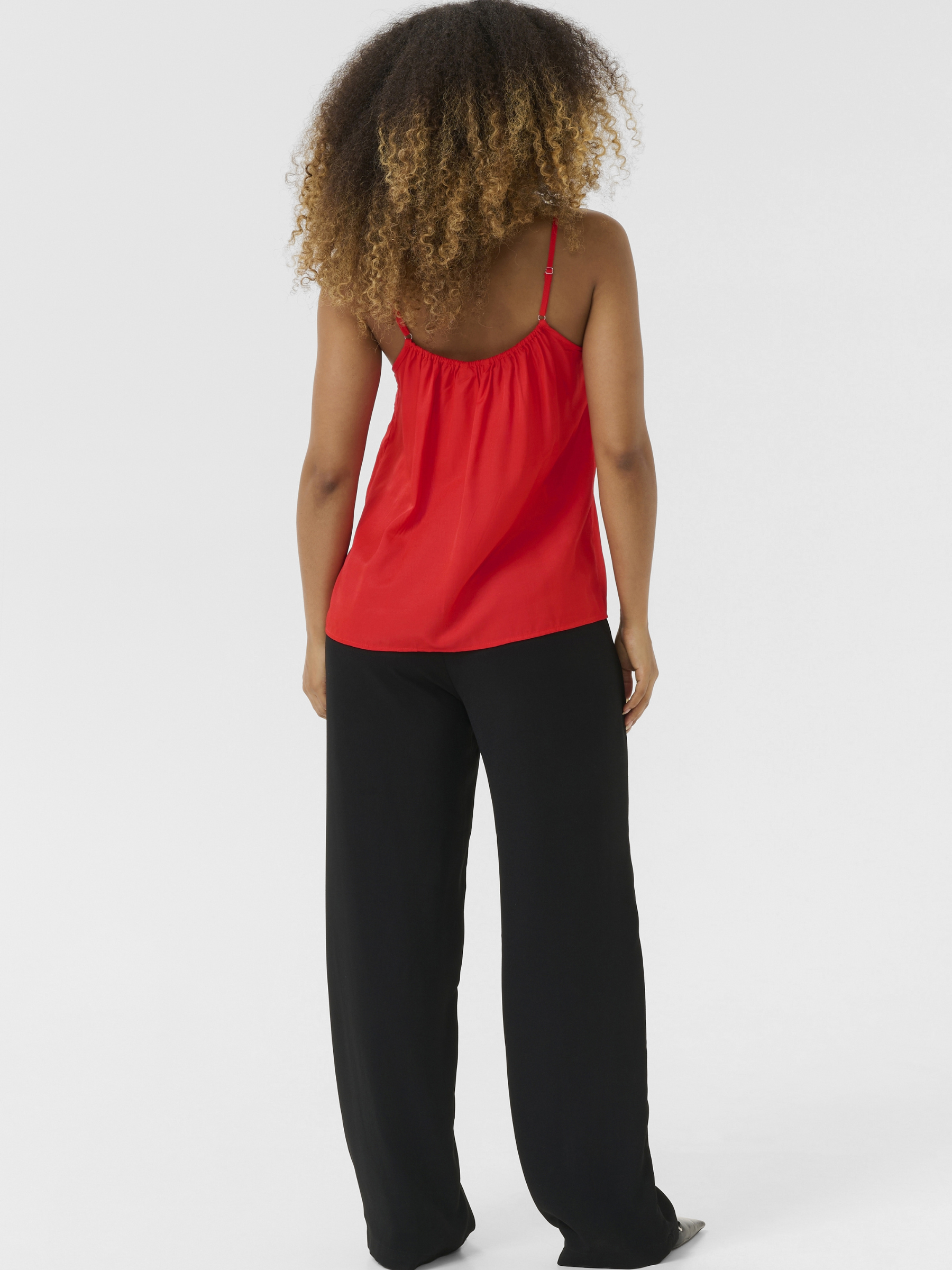 Cream Anna women’s A-line camisole top with lace neckline detail, adjustable straps and hip-length fit, styled with jeans.