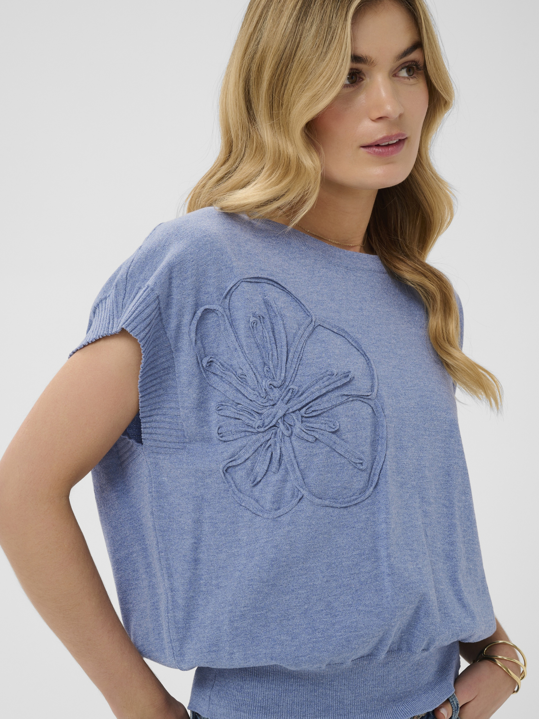 Cream Dela Knit With Deco Slipover lightweight knit top with floral applique detail and short sleeves.