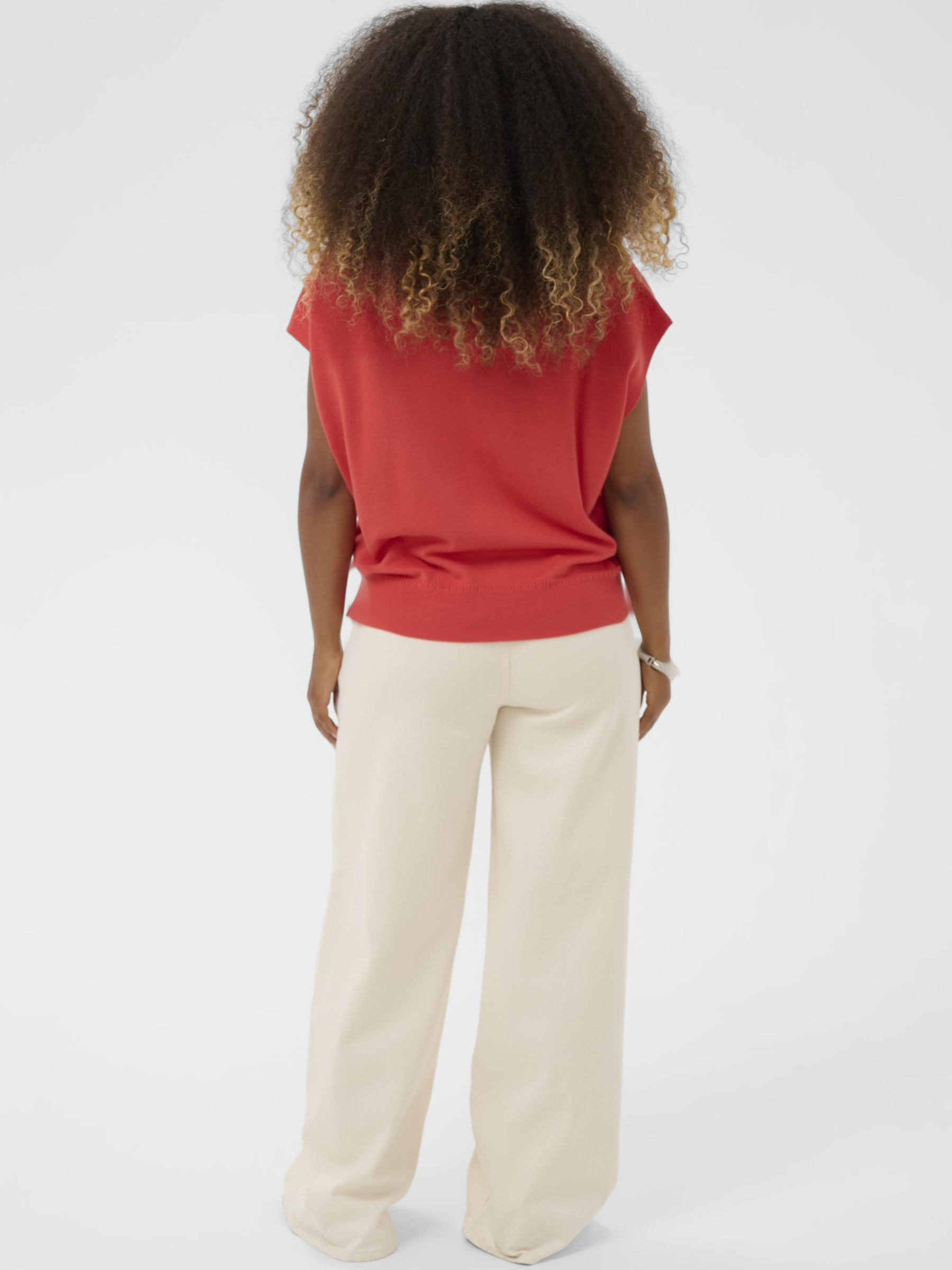 Cream Dela Slipover women’s relaxed fit knitted slipover with sleeveless design and hip-length cut, styled layered over a shirt.