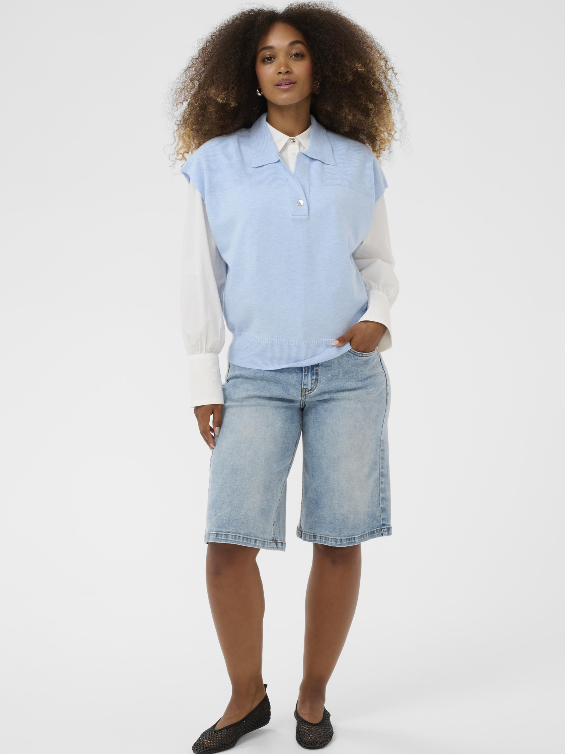 Cream Dela Slipover women’s relaxed fit knitted slipover with sleeveless design and hip-length cut, styled layered over a shirt.