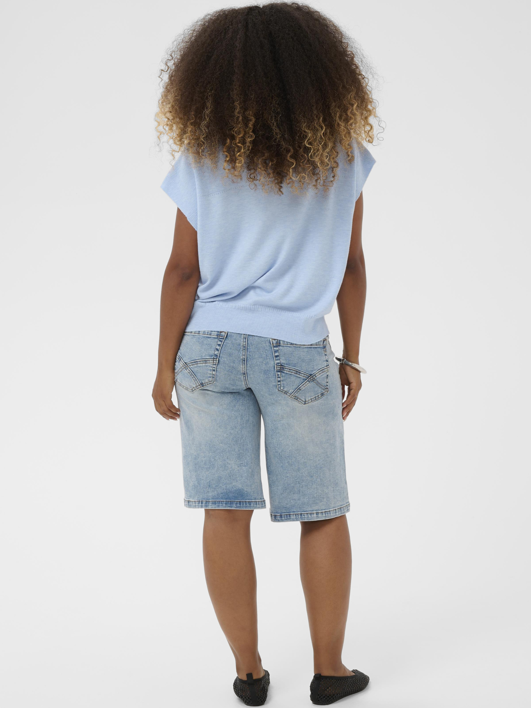 Cream Dela Slipover women’s relaxed fit knitted slipover with sleeveless design and hip-length cut, styled layered over a shirt.