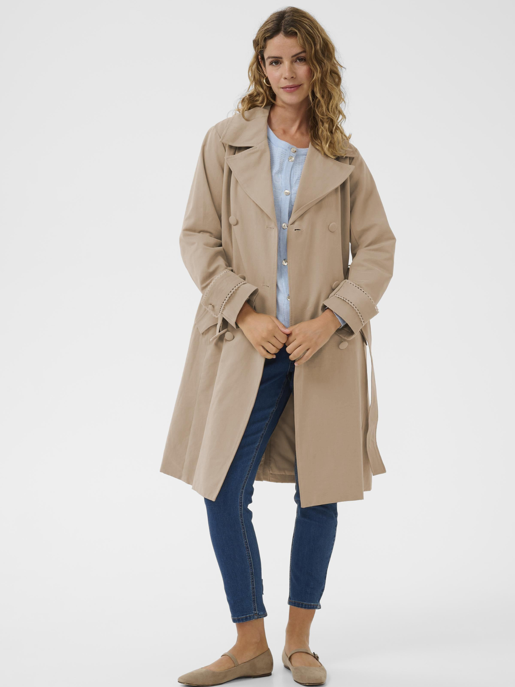 Cream Drookie Trenchcoat longline double-breasted trench coat with belt and tailored lapels.