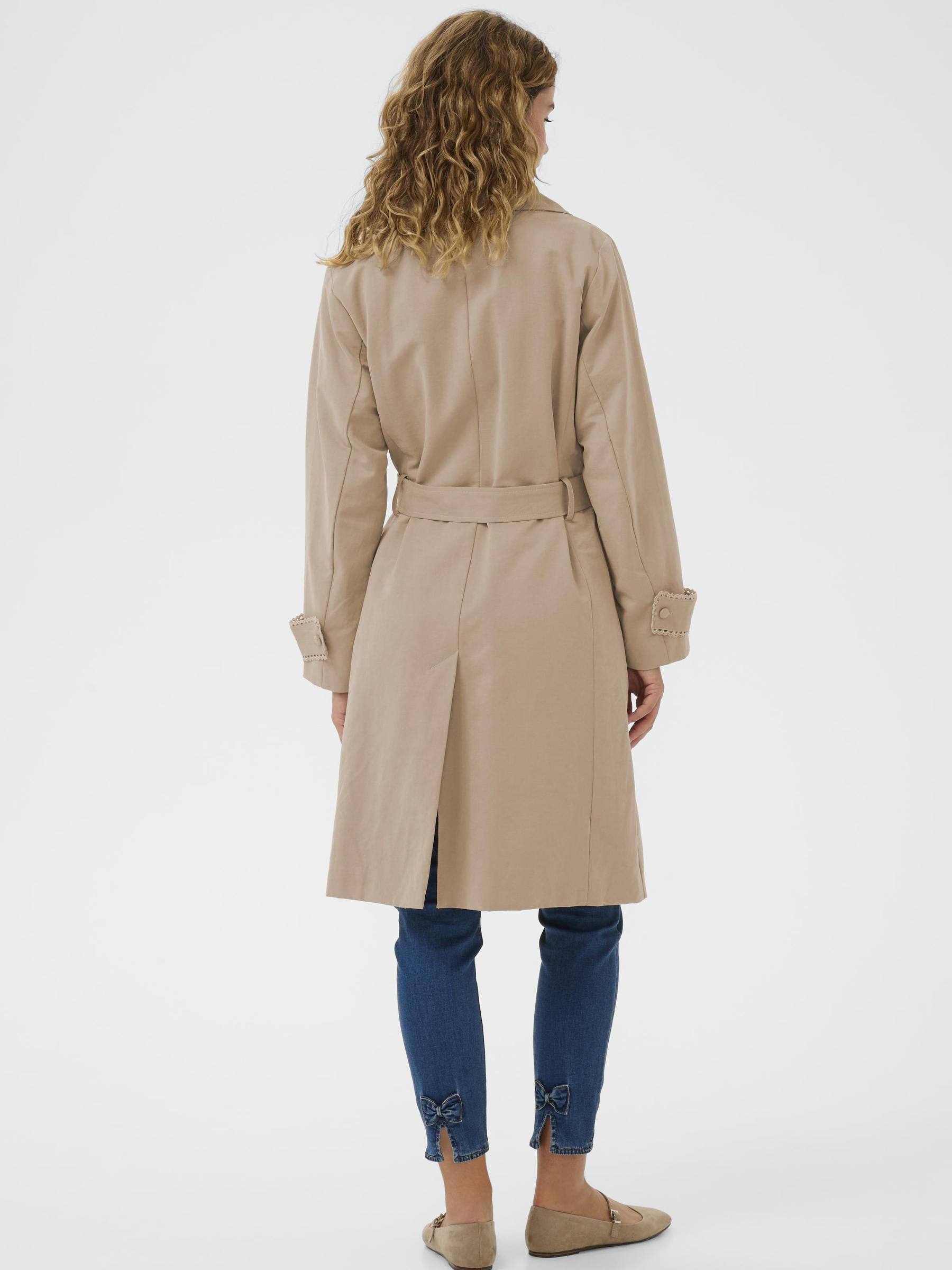Cream Drookie Trenchcoat longline double-breasted trench coat with belt and tailored lapels.