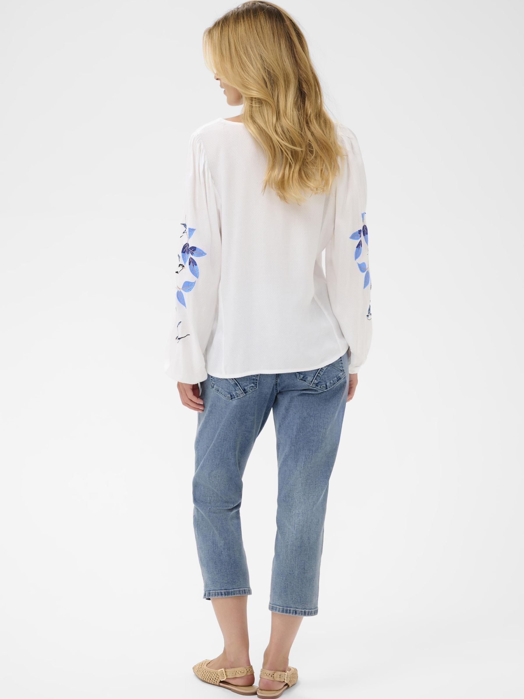 Cream Floriza V-neck blouse with embroidered blue bird detail on sleeves in lightweight viscose.