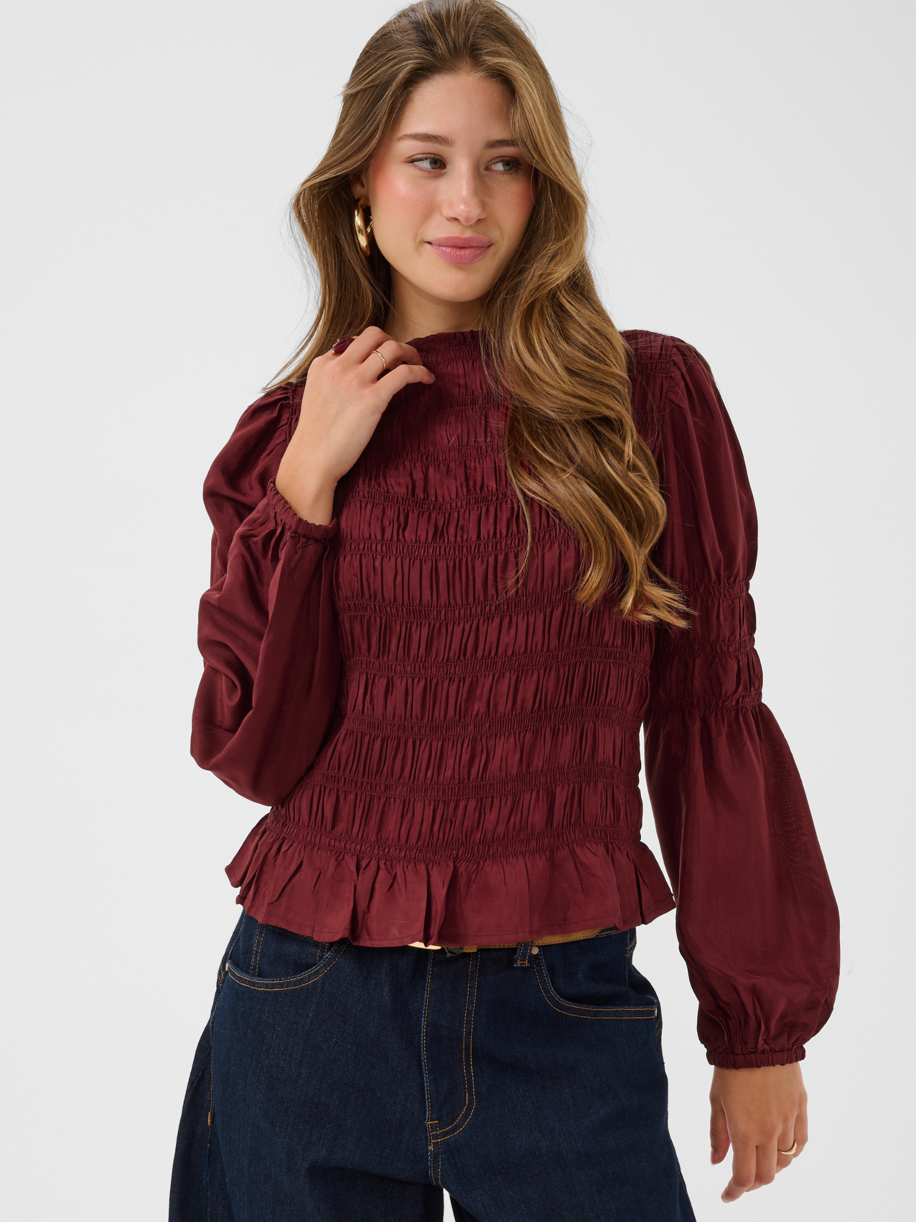 Cream Henva Blouse with shirred texture design and frill hem.