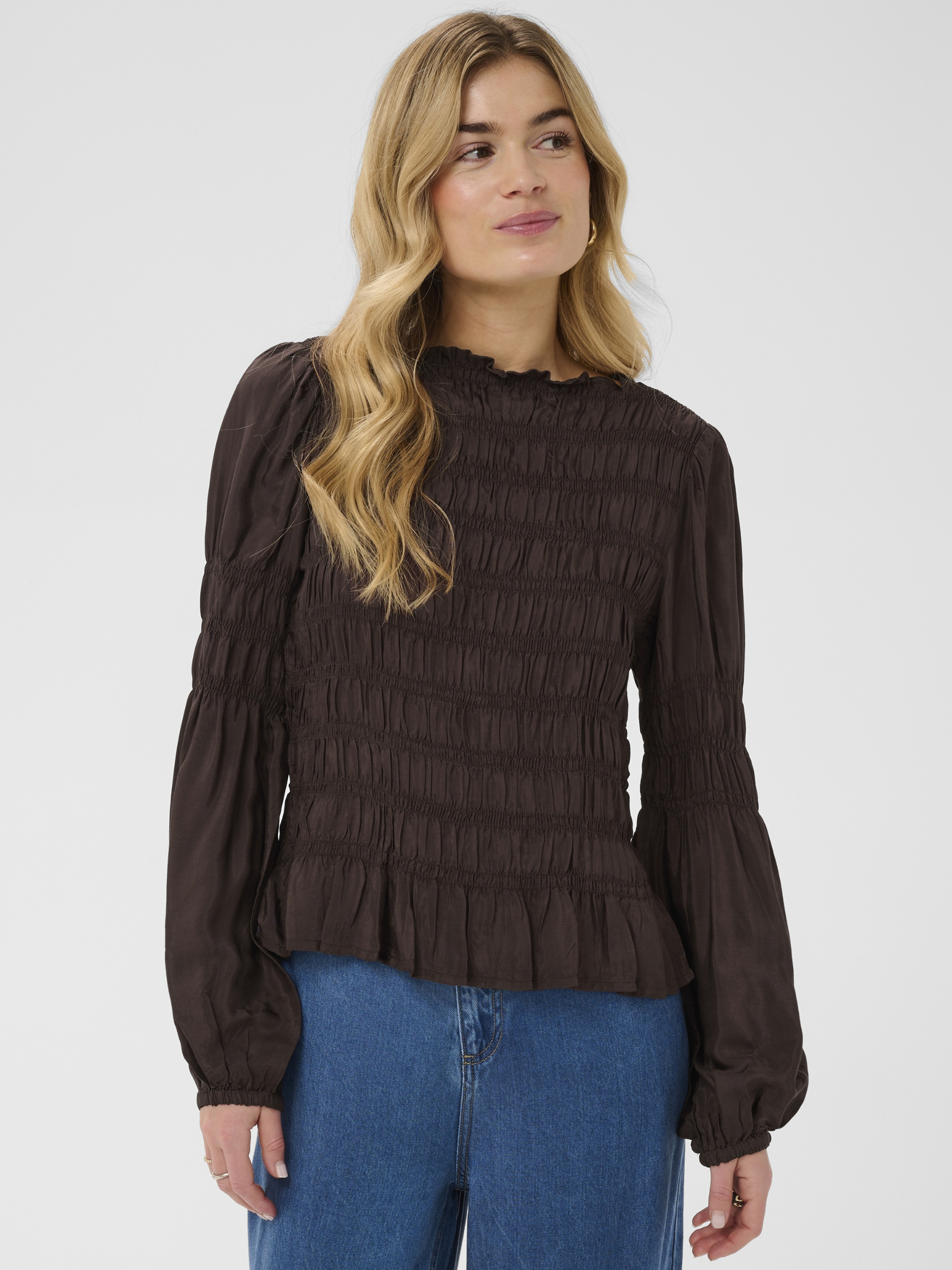 Cream Henva Blouse with shirred texture design and frill hem.