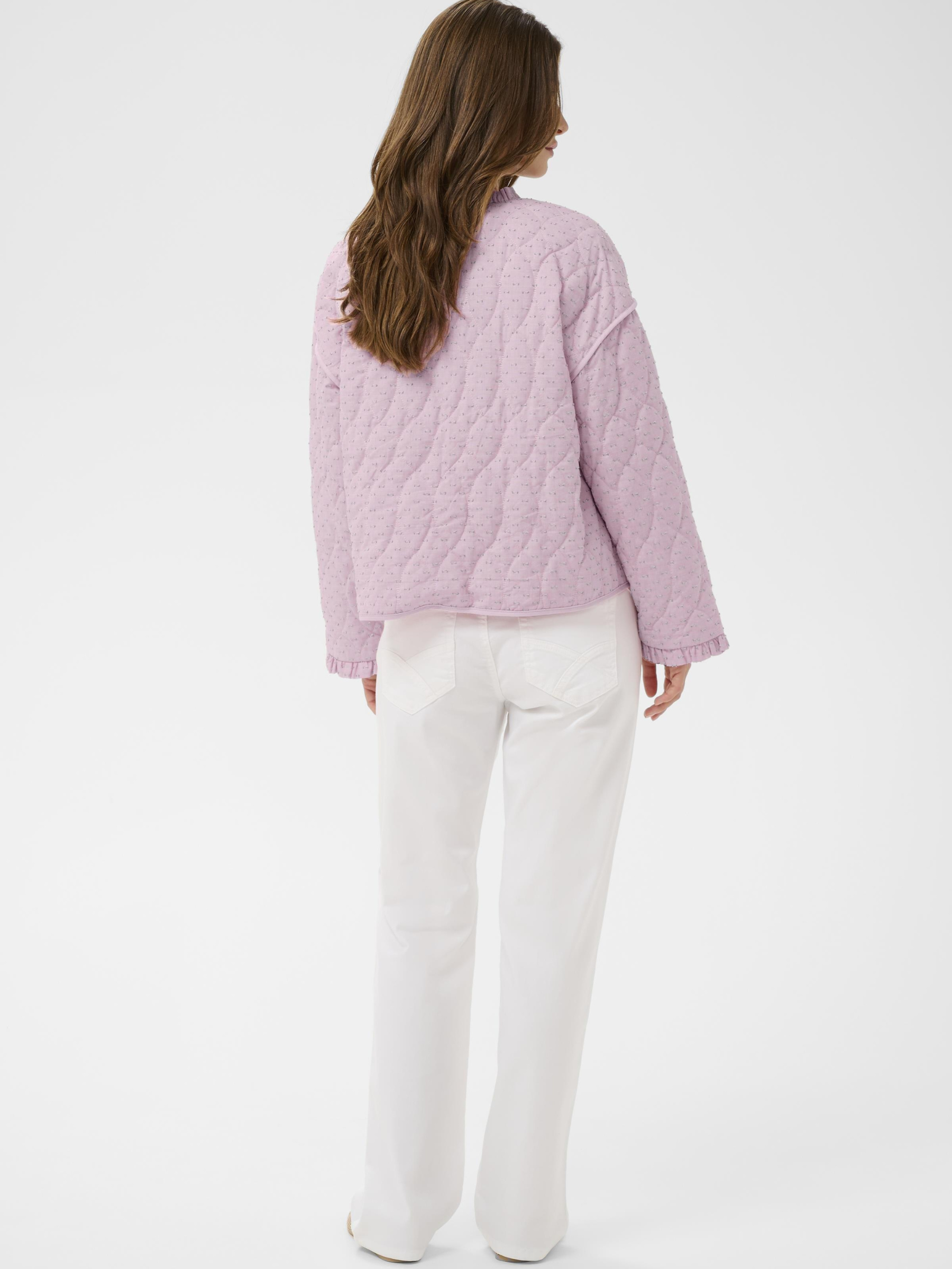 Cream Lummi quilted cotton jacket with round neckline, ruffle trim and button front in lightweight textured fabric.