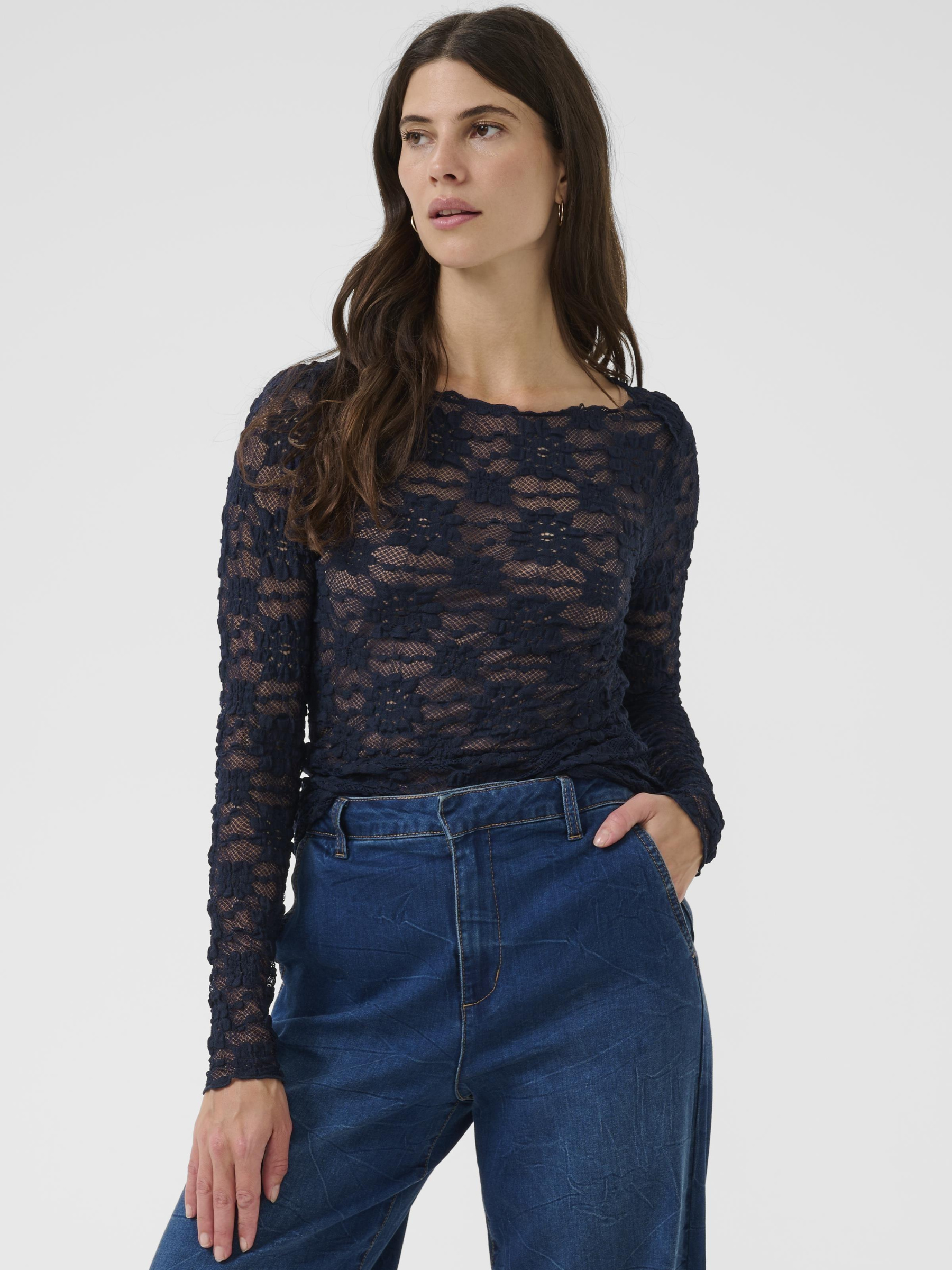 Cream Maddie Blouse women’s slim-fit lace top with long sleeves and hip-length silhouette, styled with trousers.