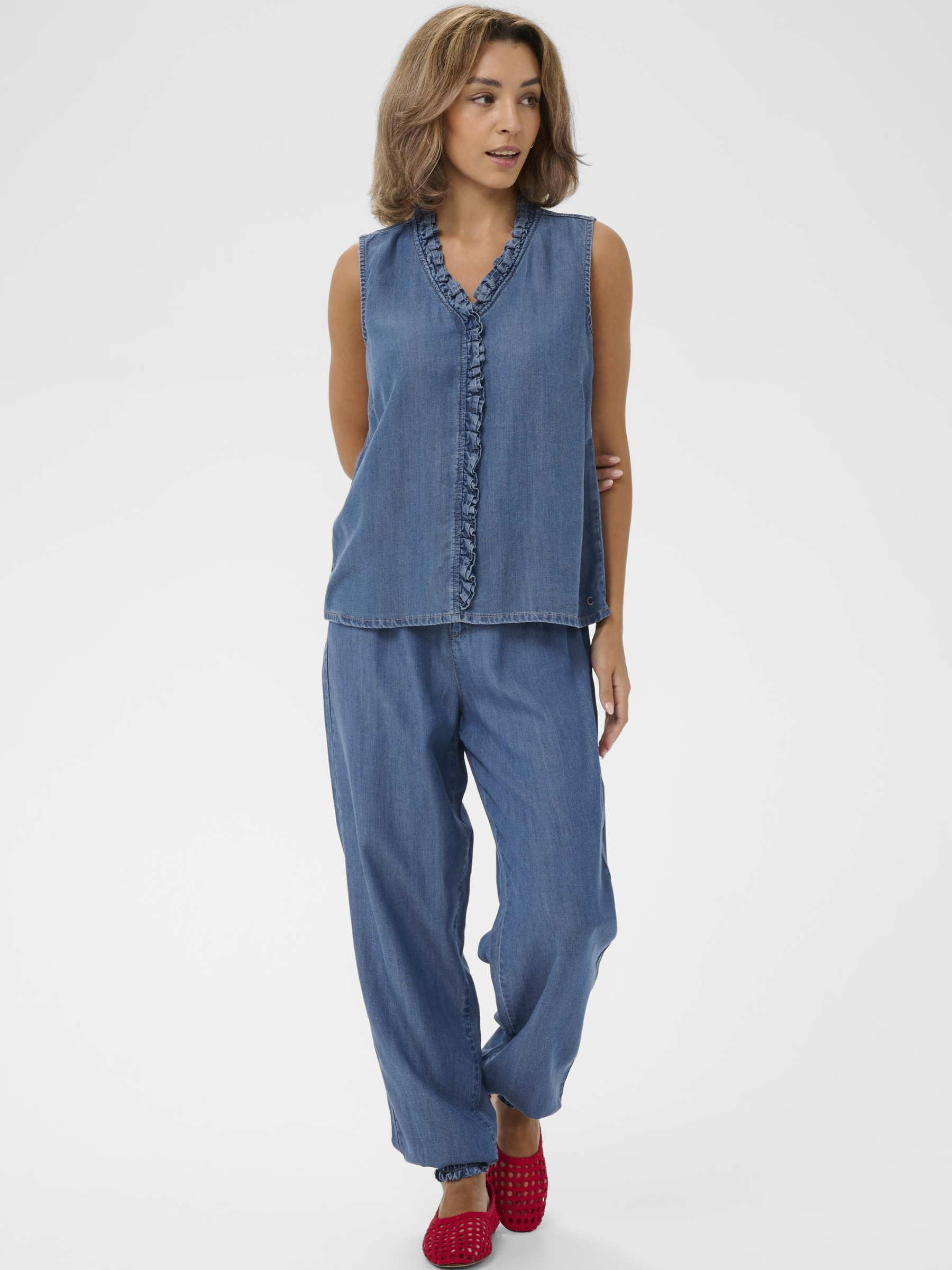 Cream Molly Sleeveless Blouse in soft lyocell with V-neckline and ruffle front detail.