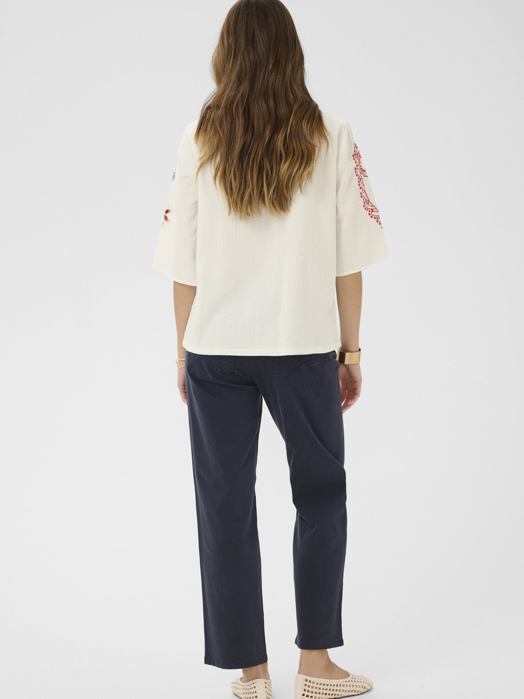 Cream Rosetta Blouse in cotton with multicolour embroidery and tassel tie neckline detail.