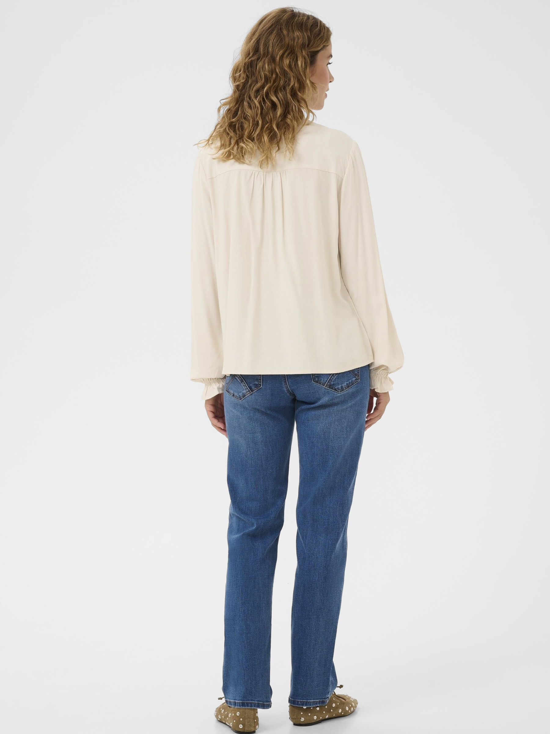 Cream Venea Shirt, women’s straight fit viscose blouse with long sleeves and hip-length cut, styled with jeans for a smart casual look.