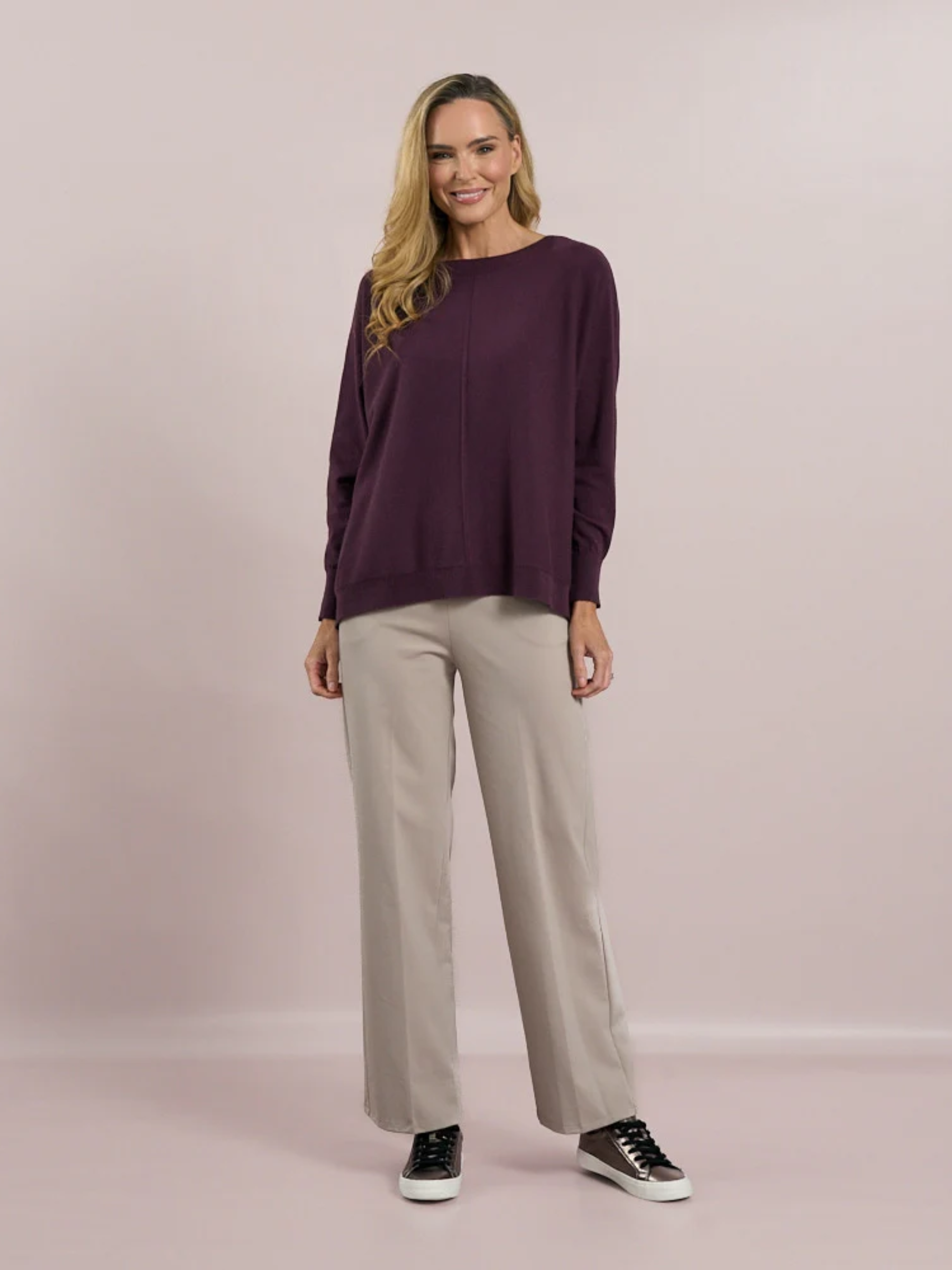 Deck by Decollage tapered sand trousers with a wide waistband, soft pleats, and ankle-length fit. Designed for a sleek, flattering silhouette in a neutral tone-perfect for smart-casual styling.