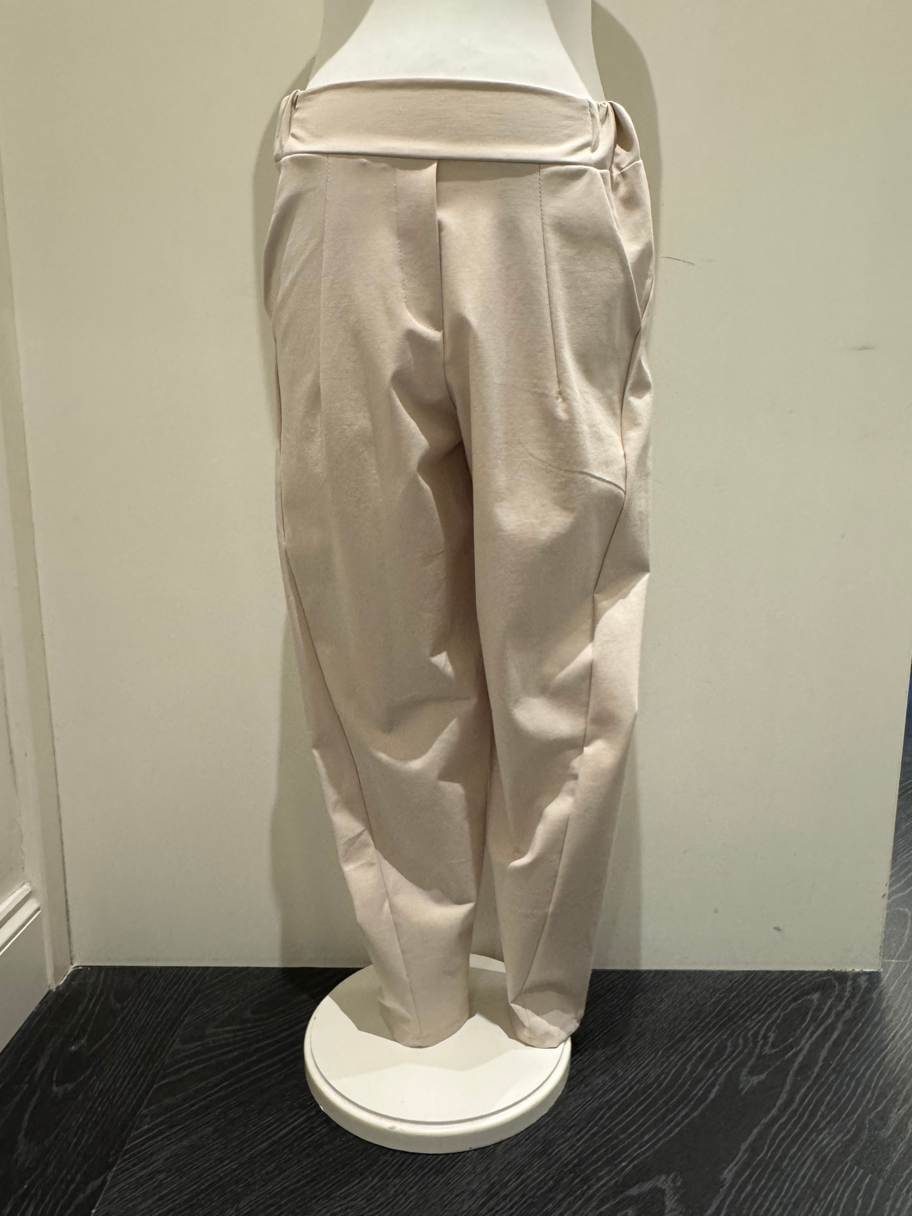Deck by Decollage tapered sand trousers with a wide waistband, soft pleats, and ankle-length fit. Designed for a sleek, flattering silhouette in a neutral tone-perfect for smart-casual styling.