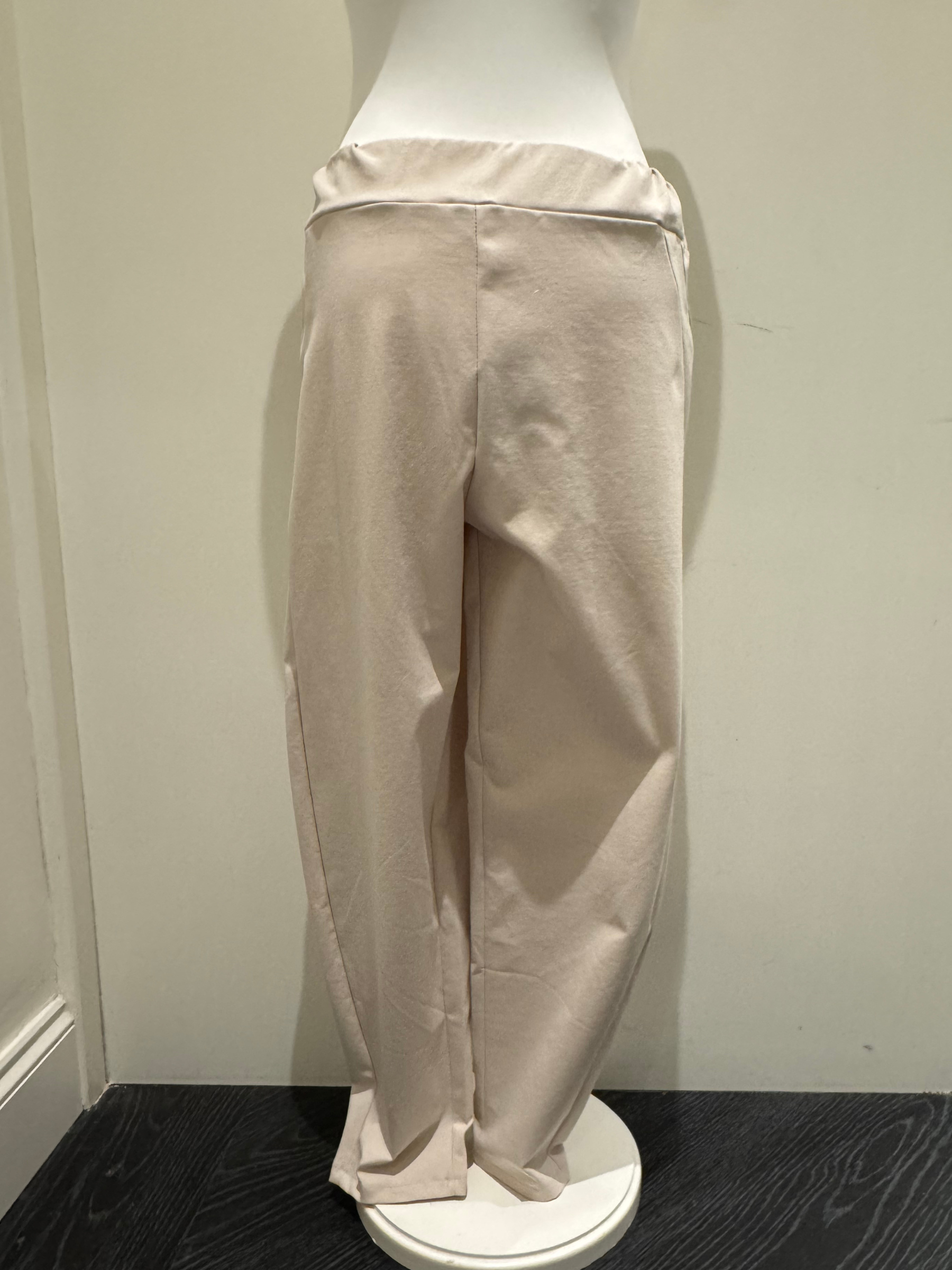 Deck by Decollage tapered sand trousers with a wide waistband, soft pleats, and ankle-length fit. Designed for a sleek, flattering silhouette in a neutral tone-perfect for smart-casual styling.