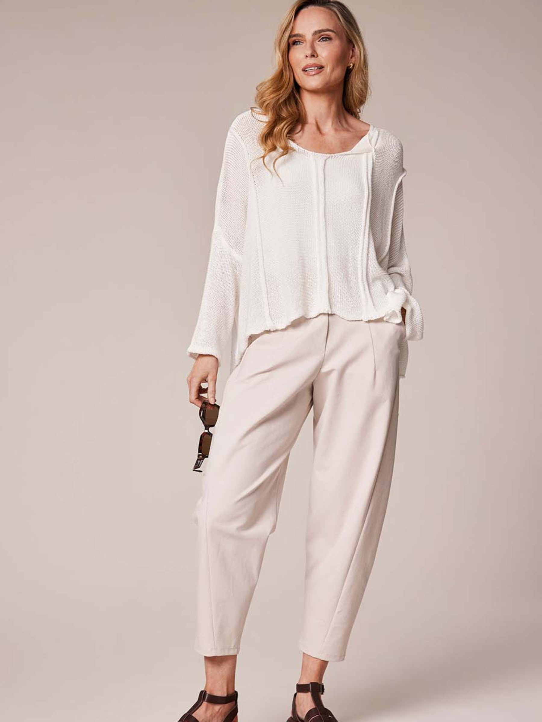 Deck By Decollage 2511 tapered tailored trousers with high-rise waistband and cropped ankle-length finish.