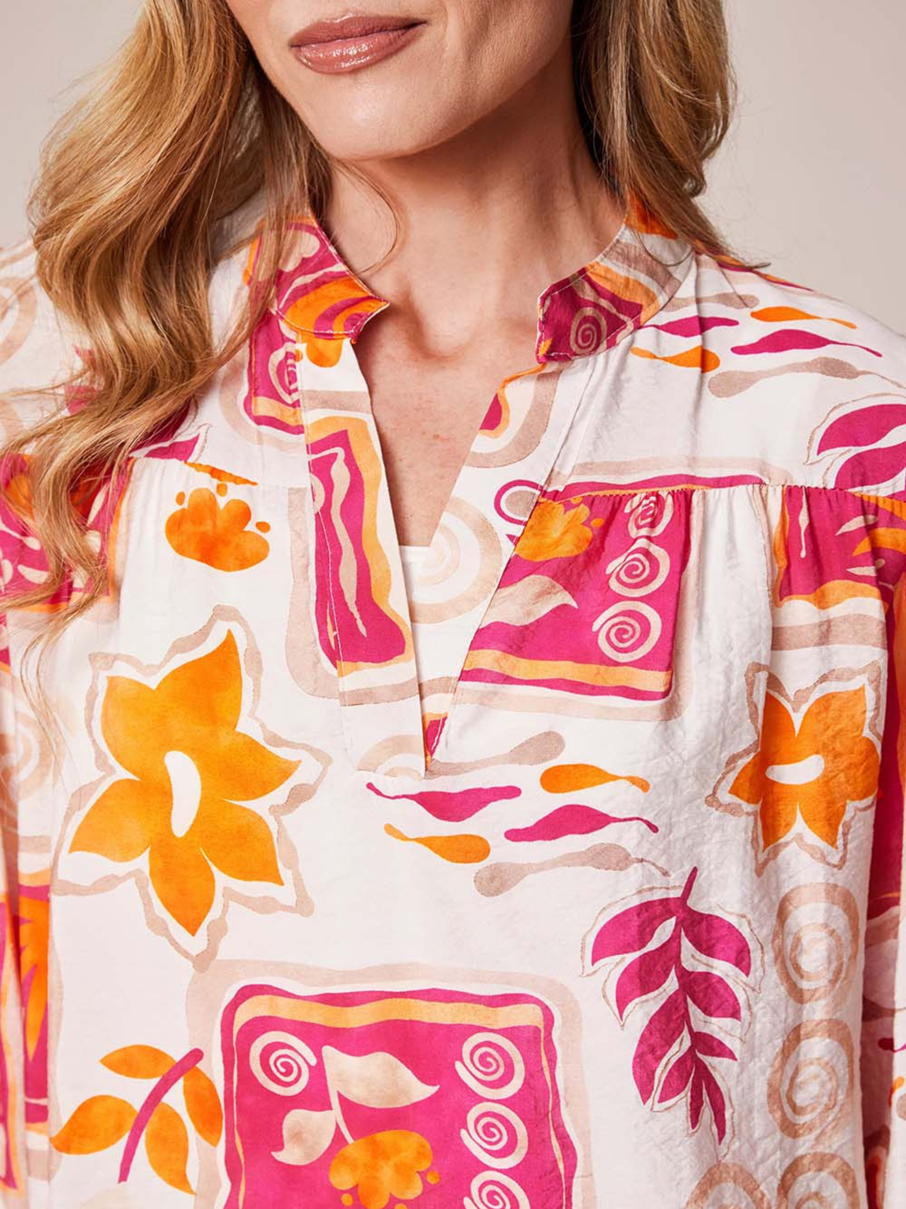 Deck By Decollage MC18022S printed blouse with notch neckline and long sleeves in lightweight fabric.