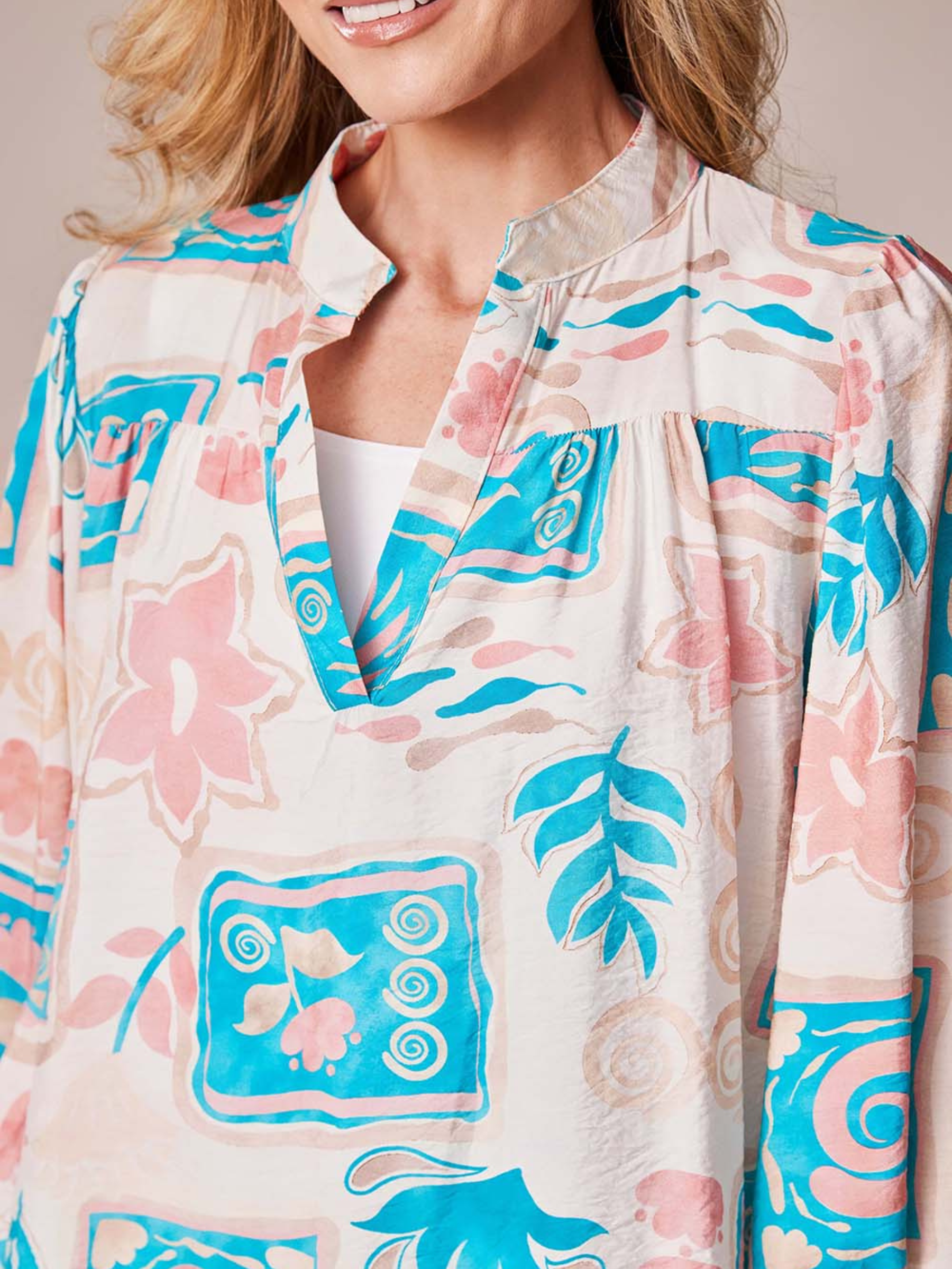 Deck By Decollage MC18022S printed blouse with notch neckline and long sleeves in lightweight fabric.