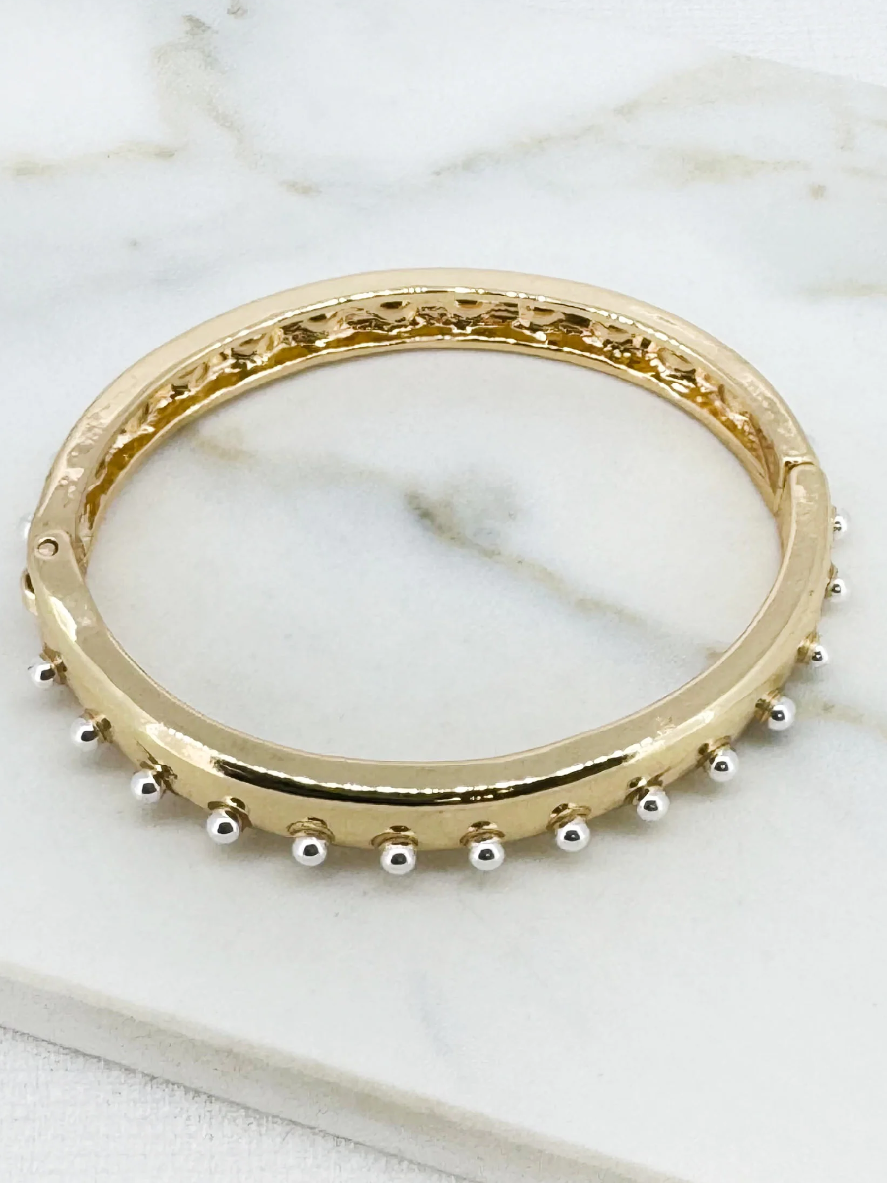 Envy 4925 Two Tone Stud Hinged Bangle Bracelet with polished band and stud detailing.
