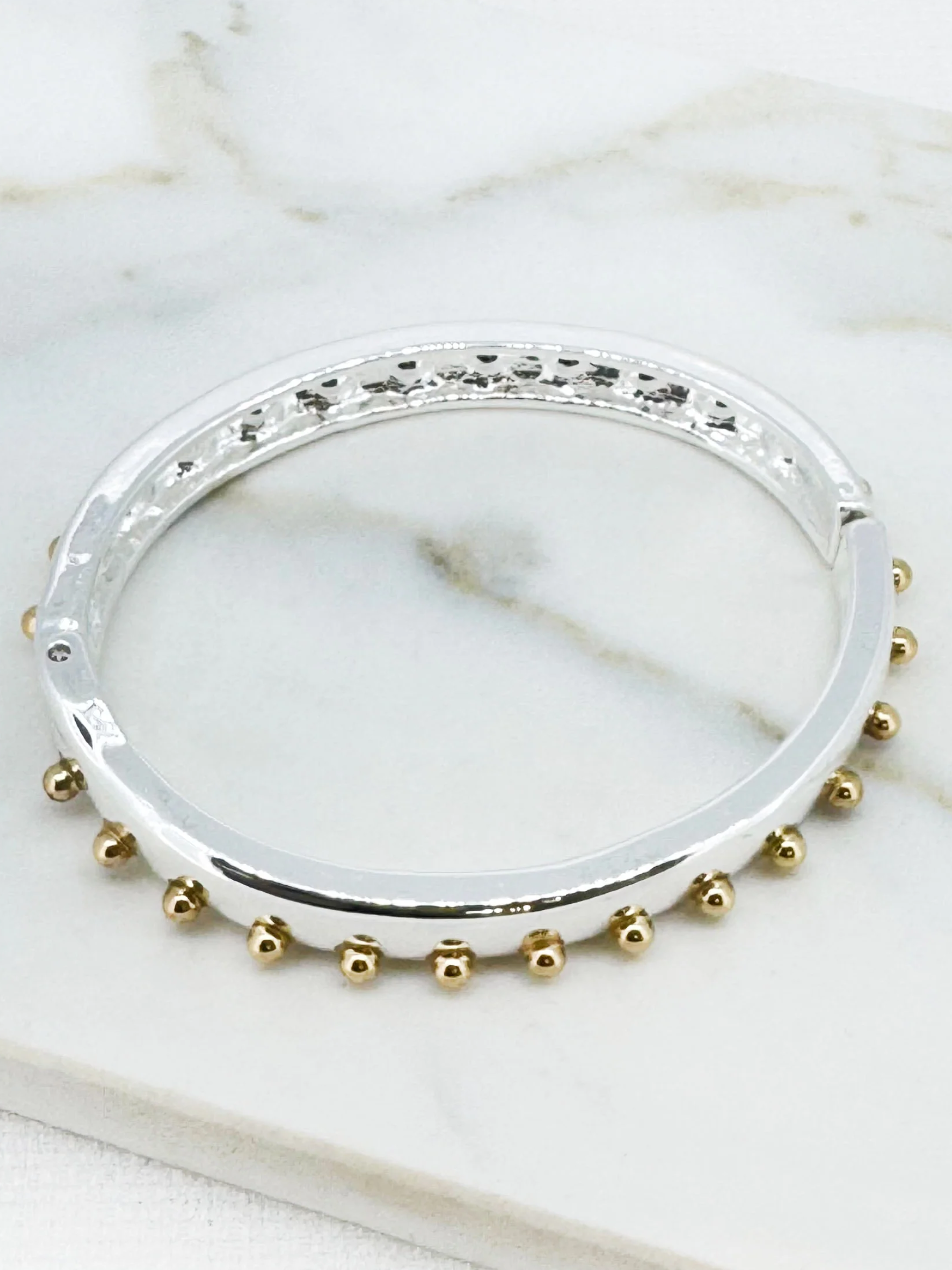 Envy 4925 Two Tone Stud Hinged Bangle Bracelet with polished band and stud detailing.