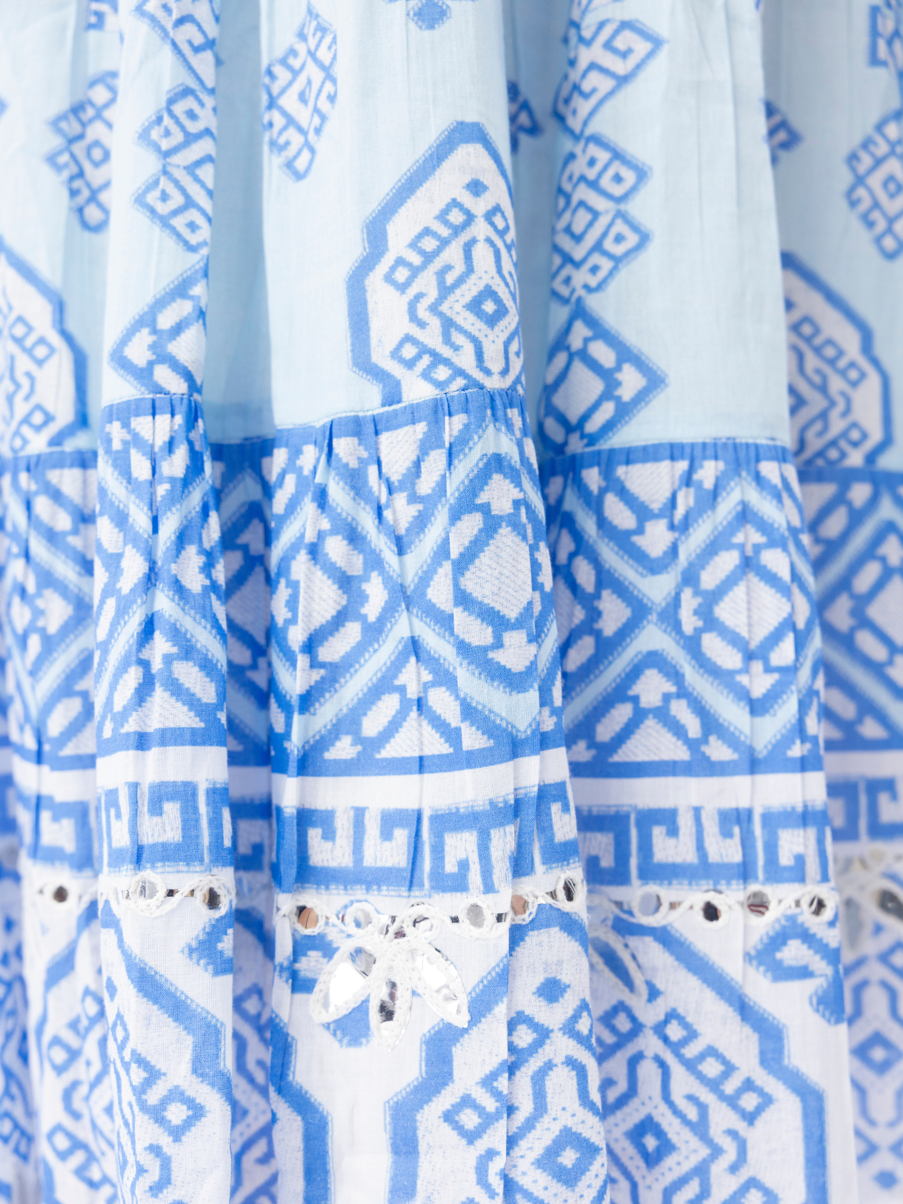 Escape 40141 Carla Dress sleeveless tiered A-line dress with notch V-neckline, button and tassel detail, and mid-calf length in printed design.