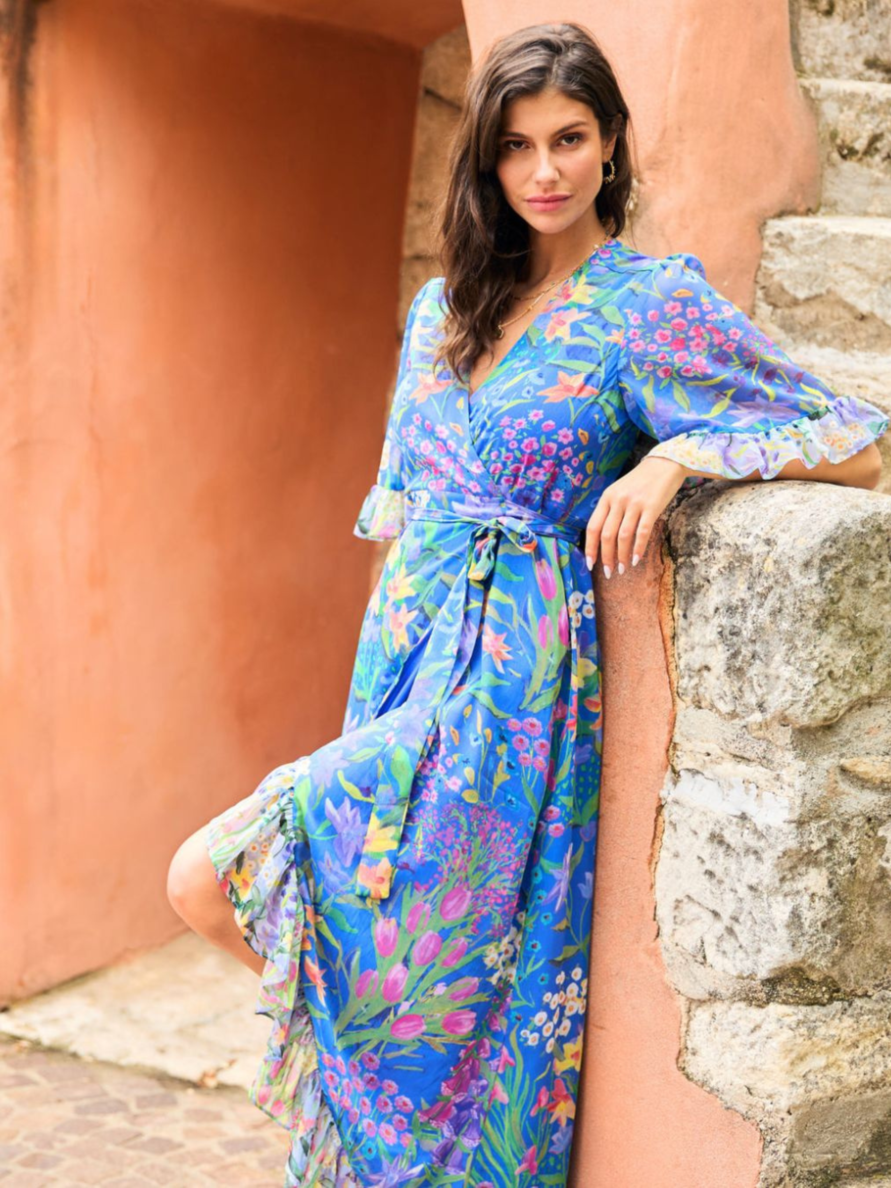 Hope & Ivy Avaline Floral Frill Trim Maxi Wrap Dress – women’s blue floral wrap dress with frilled hem and flutter sleeves. Hand-designed print with tie waist. Perfect for weddings, garden parties, and special occasions.