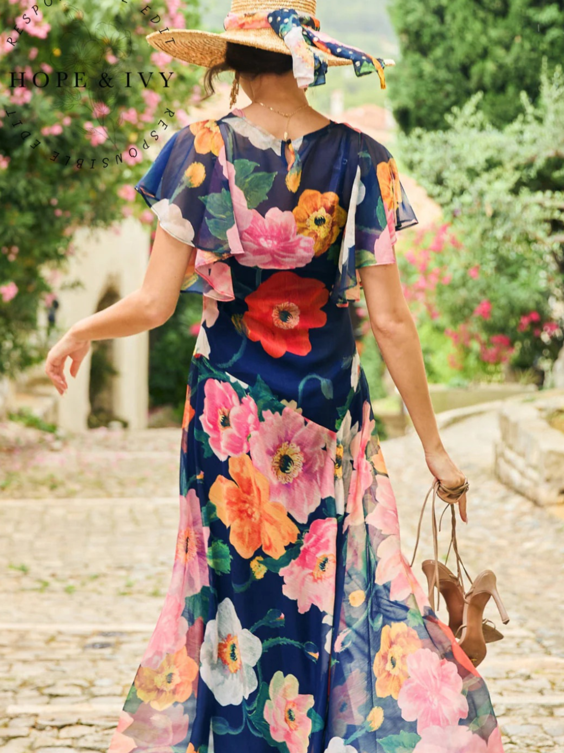 Hope & Ivy Jean Floral Dress – sustainable cowl-neck maxi dress with waterfall sleeves and hand-designed poppy print in red, pink, and orange. Made from 100% recycled materials. Perfect for weddings and summer occasions.