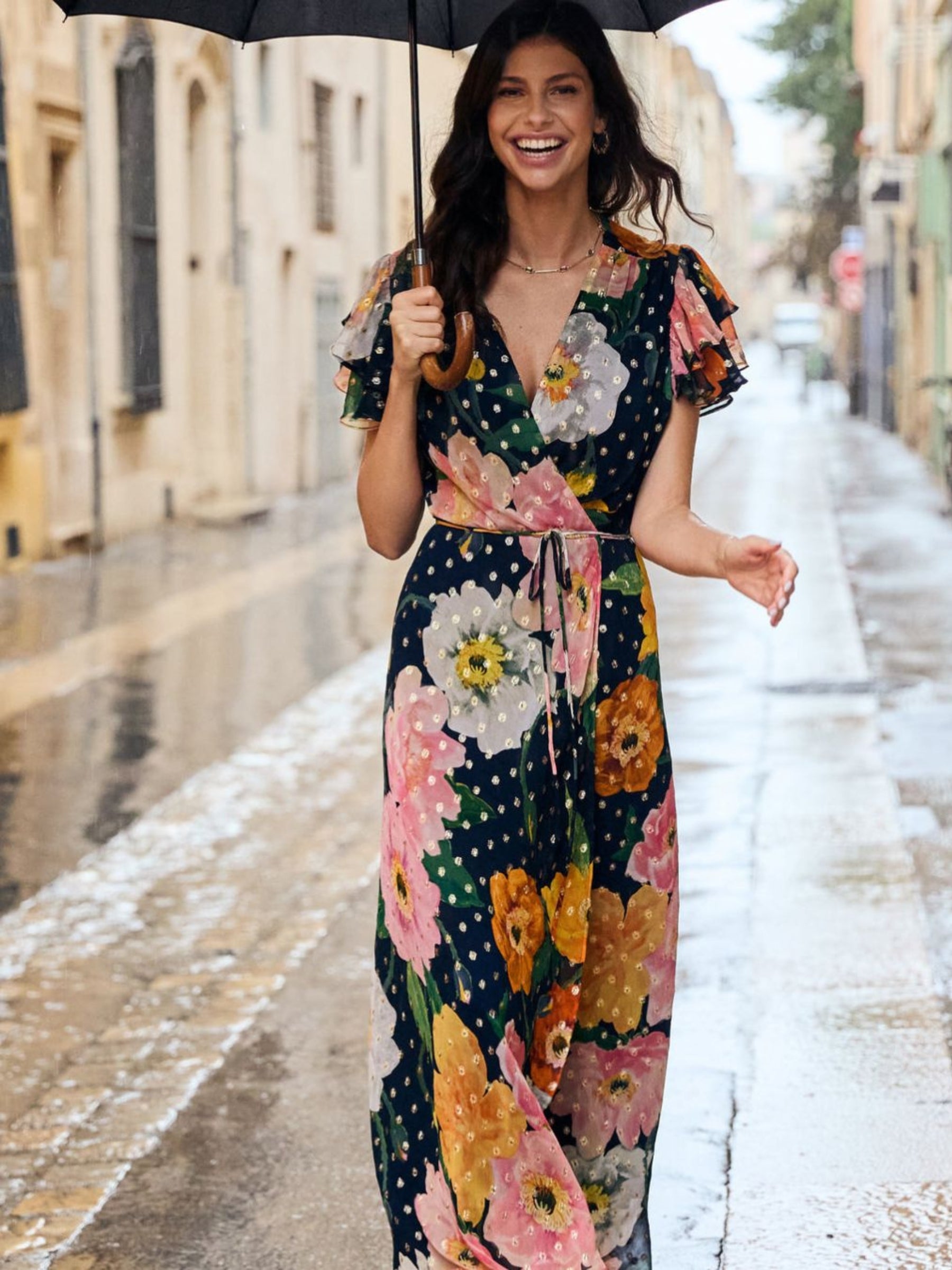 Hope & Ivy Marlene Floral Dress – floral wrap maxi dress with pink, orange and ivory blooms, gold Lurex detail, flutter sleeves and tie waist. Perfect for weddings, garden parties and summer events.