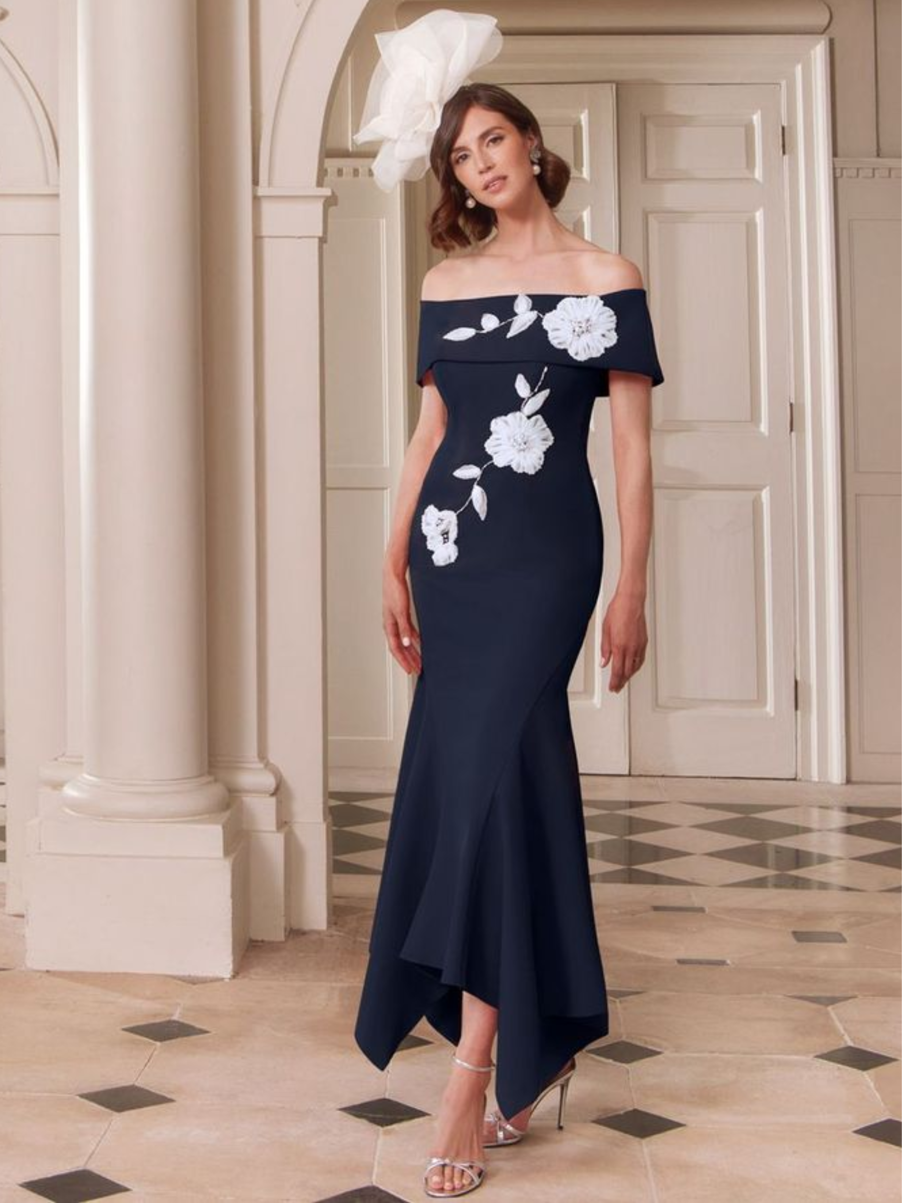 John Charles 29312 Navy/Ivory Dress with bardot neckline, chiffon appliqué, beaded detailing and fluted midi skirt.