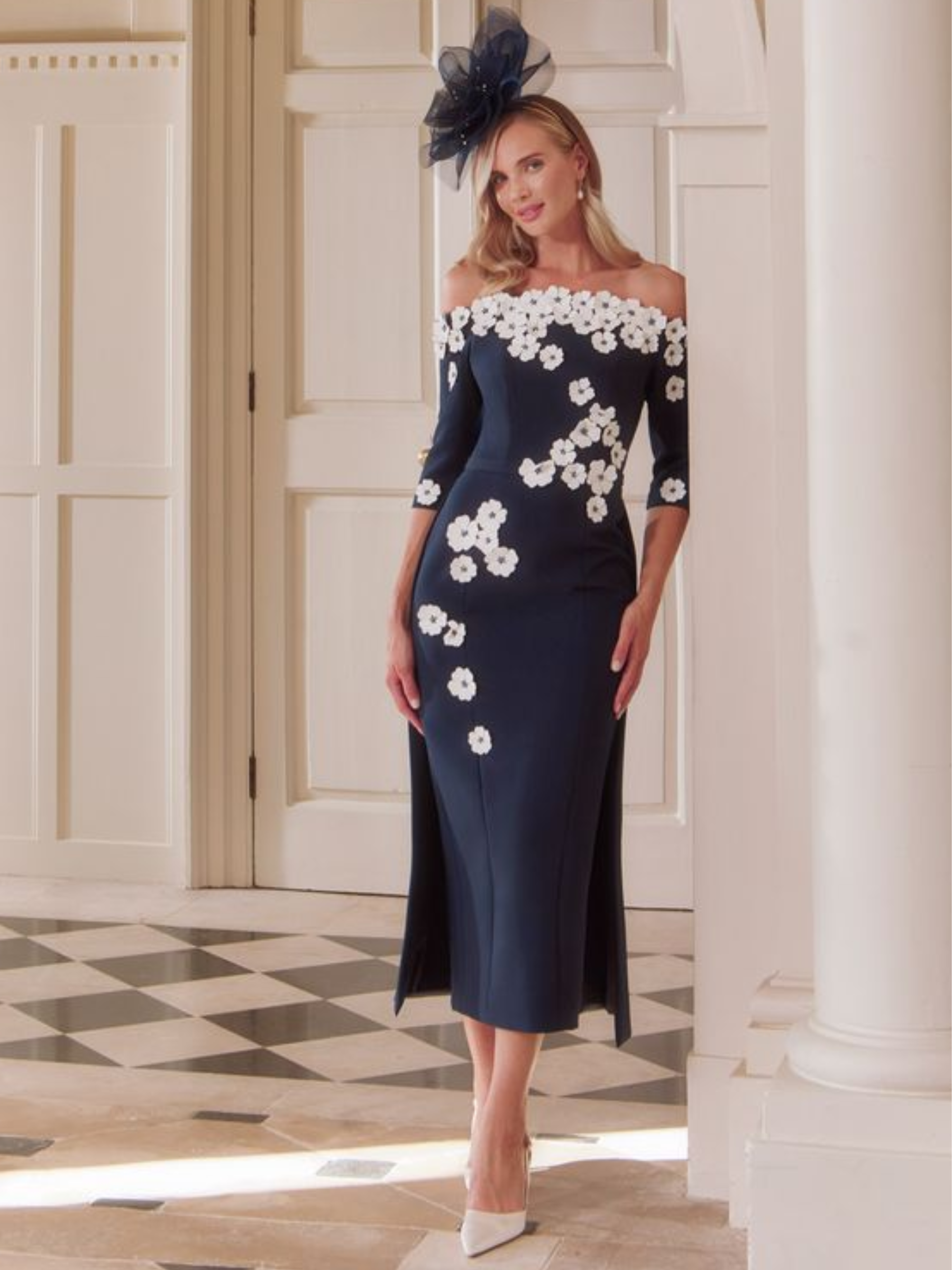 John Charles 29318 Navy/Ivory Dress with off-the-shoulder neckline, ¾ sleeves, straight midi skirt, overskirt and ivory 3D floral appliqué.